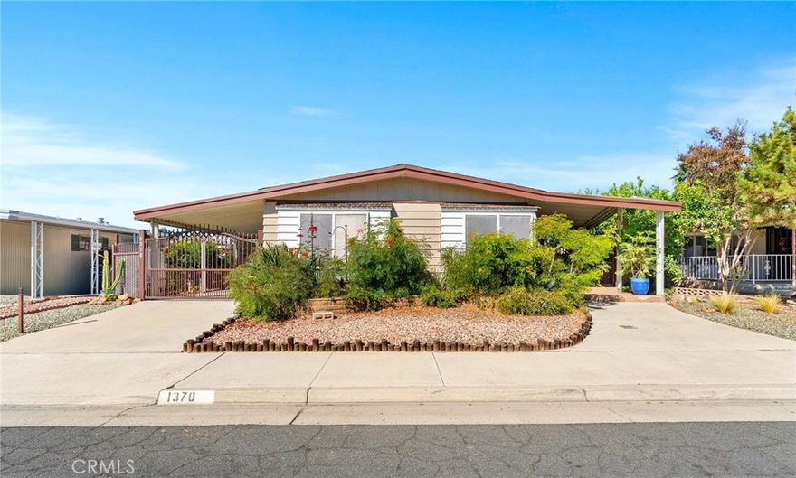 Stunning Triple Wide on a 433 recorded permanent foundation located in the 55+ community of Sierra Dawn North. As you walk up to the large vaulted awning covered front porch you feel a sense of Zen, cozy and extremely inviting. This home boasts 3 full bedrooms with laminate flooring, ceiling fans in all and custom window covering throughout. Master bedroom offers an ample size walk in closet and master bath has a his and hers sink with roman bath and separate shower and vanity area. 2nd bathroom has large walk in shower with built in seating. Built in china cabinet in dining room and built in book shelves in office area add a nice are for display. Convenient indoor laundry room with sink and cabinets are great. The interior and exterior of the home flaunts pride of ownership with custom interior paint and custom window coverings. The skylights in kitchen and Livingroom enhance the natural lighting of the home. You will instantly feel relaxed when you step out into the back patio off the master bedroom-very private, lattice enclosed "catio" and Timber Teck decking. Decorative block perimeter walls, lush, but water thrifty landscaping and a built in gardening bench and shaded area for vegetable growing. You will enjoy dusk to dawn security lighting all around the house, along with a ADT security system, custom security screen doors and custom security gating front porch and driveway. Also included are a 7x20 stick built storage shed with built in shelving, lighting and electricity and a 12x64 carport awning with additional side sun guard awning.