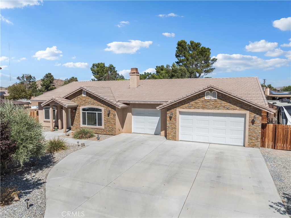 Stunning POOL home in quiet, much sought after neighborhood, this one is a must see, you will not be disappointed. Upon entering this home, you are welcomed into a warm and inviting living area filled with natural light streaming through a large picture window. The spacious layout features vaulted ceilings, and a veneer stone fireplace with gas logs and raised hearth. Neutral -toned upgraded carpet blends seamlessly with rich wood-like tile flooring. The open floor plan leads effortlessly toward the kitchen which offers modern conveniences with thoughtful design elements creating stylish yet highly functional environment suitable for both everyday living and entertaining. Beautiful polished granite counter tops with stylish backsplash, pine cabinetry, complemented by sleek stainless steel appliances. The heart of the home features a beautiful oversized island, perfect for casual dining, or gathering with friends and family. The kitchen also offers walk in pantry and pendant lighting. Split floor plan with a large primary suite on one side of the home and a guest room, guest bath and junior suite with bath on the other side. The spacious master suite designed for comfort and relaxation provides a roomy walk in closet with luxury built in closet organizer with glass panel doors. En suite bath highlights dual sinks set in granite counter tops, walk in shower and a separate soaking tub/shower . The junior suite also displays custom closet organizer, granite counter tops in bath with ample storage, full tub/shower combination along with thoughtful details that add both charm and functionality. Indoor laundry with storage and sink, recessed lighting, ceiling fans in all rooms and 2 water heaters. The huge, oversized three car garage measures over 1,000 sq ft. with upgraded insulated garage doors, pull down attic access with ladder, ultra quiet genie garage door opener with my Q app, an abundance of LED flush mount lights and built in cabinets. The single garage slab height was built to easily convert into a room. Enjoy resort style living in your own backyard with a sparkling PebbleTec salt water pool, complete with stacked stone spa, soothing water features and elegant deck jet, with wifi controlled app. Covered cozy patio, RV parking with 30 amp service, tile roof and lots of concrete. Well manicured low maintenance front yard, 5 outside hose bibs, 6 outside plugs, including Xmas light outlet at eaves. Come and check this one out, it will not last long!