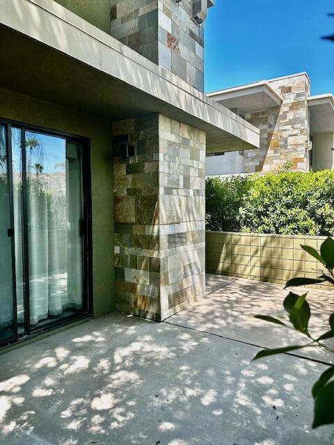 This beautiful Biltmore Colony condo is a lower corner end unit offering two bedrooms, two walk in closets, and two mosaic tiled bathrooms with quartz countertops. Recently installed light wood-look flooring is in the main areas and bedrooms, tile flooring is in the kitchen and bathrooms. The kitchen has a new stainless refridgerator, quartz countertops and a breakfast bar. There is a new washer and dryer in the laundry room and a two car tandum attached garage! Other features include two walled patios, a fireplace, and double pane windows throughout the unit. The Biltmore Colony has three refreshing pools and spas with lounge chairs and mountain views and the main pool area has a shaded dining pavillion and cabanas. Each pool area features a BBQ area. There's a party room, and a nicely appointed gym with machines and cardio equipment! This is a great South Palm Springs location close to Smoke Tree Commons and just minutes to downtown Palm Springs! YOU OWN THE LAND!