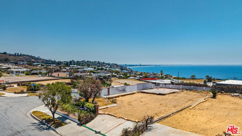 Panoramic Ocean View Corner Lot in Sunset Mesa, on a peaceful, dead end street! 6,579 sq ft nearly all flat pad, this property offers a great opportunity to build your ideal home in one of the Westside's most desirable coastal neighborhoods. The original structure was approx. 2,061 sq ft, an outstanding starting point/footprint for a new custom build. With wide ocean views, underground utilities, and a quiet setting, this lot offers a rare chance to create something special. Sitting just above the Getty Villa, Sunset Mesa provides easy access to both Santa Monica and Malibu shopping. Located within the Malibu-Santa Monica School District. CC&Rs in place help preserve the open view corridors that make this area so unique (buyer to review and satisfy self in all regards; broker/agents make no warranty as to the same). Phase 1 and Phase 2 clean up from the Army Corps of Engineers has been completed. Bring your vision to life and take advantage of a prime lot, in a great location.