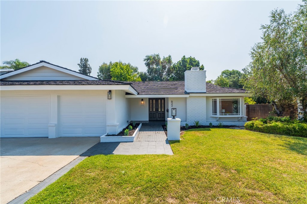 Welcome to this beautifully renovated single-story, 3-car garage home, where modern design meets luxurious comfort. Located on a quiet cul-de-sac in the foothills of a highly desirable neighborhood in Glendora, CA. This stunning property boasts a spacious open floor plan with four (4) generously sized bedrooms and various premium features that elevate your living experience. Two full bathrooms have been tastefully renovated with modern mid-century touches. Step inside through a beautiful double door and be greeted by the inviting ambiance, enhanced by recessed lighting, new whisper white interior paint, and premium laminate wood flooring throughout the home. The heart of this home is the chef-inspired kitchen, complete with gleaming quartz countertops, all-new stainless steel appliances, and shaker-style slow-close cabinetry, perfect for both cooking and entertaining. There is a warm and inviting family room and a separate formal living room, which features a beautiful tiled fireplace, providing a perfect setting for relaxing. This home offers a 3-CAR GARAGE offering ample storage or to use as a gym/hobby space. Enjoy the lush and private backyard to host all of your special gatherings. With its thoughtful design, premium finishes, and a fantastic layout, this home is the perfect blend of modern living and comfort. Great location with award-winning Glendora school district, don't miss this chance to make this property your DREAM HOME!