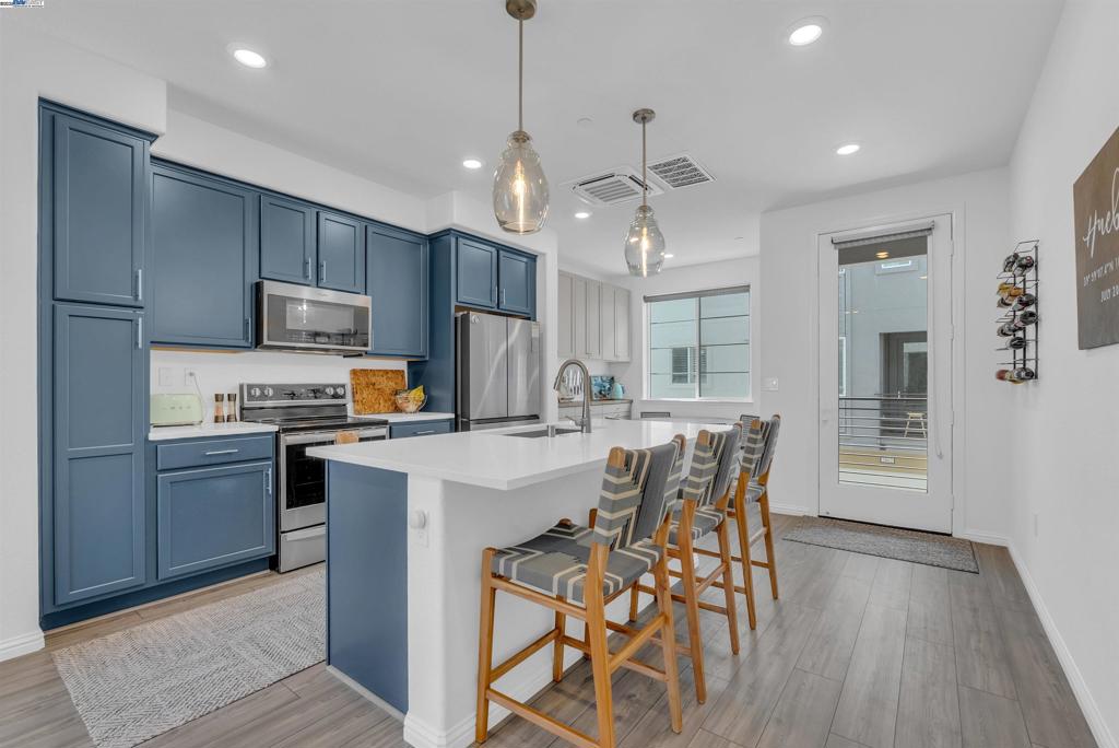 Step into modern comfort in this light and bright 2-bedroom, 1.5-bath condo within the vibrant Bay37 waterfront community. Built in 2023, this 1,138 square foot home features an open-concept living area ideal for entertaining. The kitchen boasts an island, stainless steel appliances, and custom built-in cabinetry in the breakfast nook. Experience modern living with amenities like central AC with three separate zoned smart thermostats and WiFi-enabled smart appliances. Enjoy the convenience and security of smart locks with cameras and recessed lighting, all powered by your fully paid for solar for energy bills cheaper then your dinner out. In-unit laundry is conveniently located next to both bedrooms. A private balcony provides a tranquil outdoor escape, while a generously sized two-car garage with direct access offers exceptional urban convenience a rare find in this community. Perfectly located near the Target/Safeway shopping center and the lively "Spirits Alley," home to popular spots like The Almanac and Saltbreaker, this condo also offers easy commuting with a water taxi to Jack London Square and ferry access to San Francisco. Enjoy waterfront serenity while staying connected to city life.