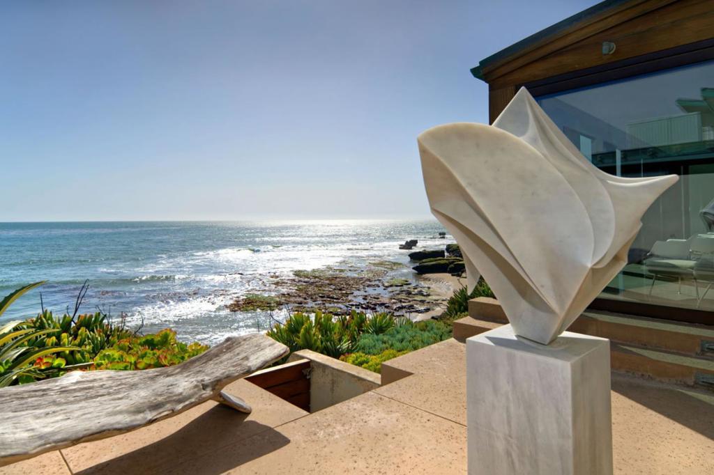 "The Surf House": Where Paradise Meets the Pipeline. Experience surfing nirvana at Santa Cruz's most coveted coastal retreat. Imagine waking to an endless canvas of turquoise waves, framed by floor-to-ceiling windows in your very own architectural masterpiece. This isn't just beachfront living; it's a surfer's sanctuary designed by a renowned architect. A symphony of style: Moroccan gates beckon you into a world of views, intricate plaster walls, and radiant concrete floors, while a gourmet kitchen fuels your post-surf adventures. Your playground awaits: Unwind on the deck, or grab your board from the dedicated surf room and descend via private stairs to your own personal wave haven. Afterward, Indulge in the hot tub, stargaze on the rooftop deck, bring all your friends and family in the luxurious guest house. Live the dream: Explore nearby charming shops and galleries, all while enjoying unparalleled connectivity. Escape the ordinary: This isn't just a house; it's a lifestyle. Where surfing isn't a hobby, it's a way of life. Vacation only 30 minutes from Silicon Valley, "The Surf House" offers a rare blend of luxury and laid-back coastal living. Experience the ultimate surfer's retreat. Expand your horizons: Add an additional 800SF by creating a luxurious owner's wing.