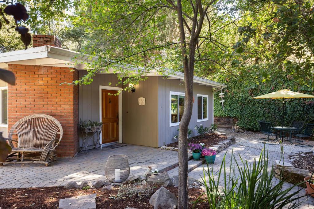 This charming two bedroom, one bathroom home is a sunlit retreat nestled in Carmel Valleys desirable Robles Del Rio neighborhood. The cozy living room features a welcoming fireplace, while the updated galley kitchen opens to a sunny side yard through a classic Dutch door. The bathroom boasts recent upgrades including herringbone tile and a stylish new vanity. The cheerful primary bedroom is filled with natural light, and the second bedroom offers new flooring and windows. On the market for the first time in 50 years, this lovingly maintained home is the perfect introduction to the Carmel Valley Village lifestyle.