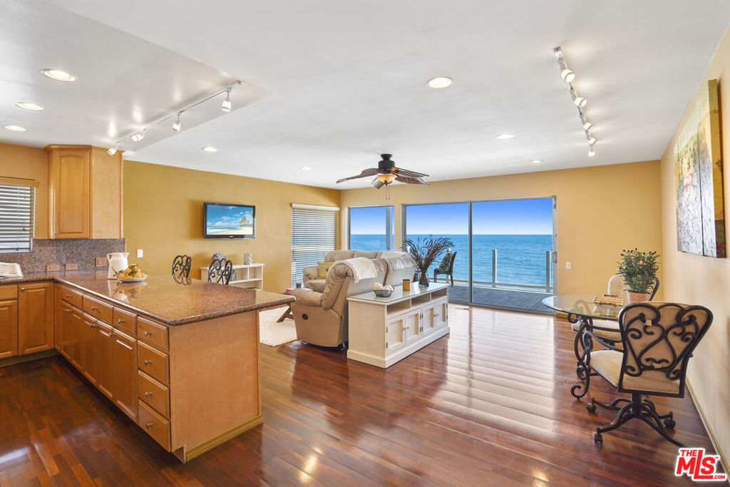 Experience the best of coastal living with this exclusive beachfront condominium on Malibu Road. The building was built and designed by actress Shirley MacLaine in collaboration with renowned architect Cliff May. This charming two-bedroom, two-bath corner unit is one of only six in the building. Enjoy coastline whitewater views by day and enchanting city lights by night. The generous primary suite includes a spa tub for ultimate relaxation, and the open kitchen features granite countertops and stainless-steel appliances to inspire your culinary delights. Nestled on a tranquil, sandy beach, this paradise includes an oceanfront balcony for you to enjoy the serene ambiance. The building features a peaceful center courtyard and the convenience of a one-car garage with additional tandem parking. Known as one of the best buildings on the "Old Road", this unit is your ideal beachside pied-a-terre, offering an escape from the heat and bustle of city life. Make this slice of Malibu beach your own and enjoy a lifestyle of peace and relaxation. Don't miss out on this unique opportunity to own a truly special retreat!