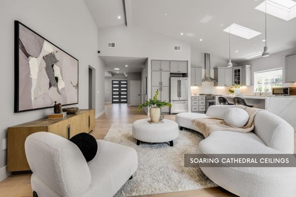 4 bed, 3 bath home offers nearly 2,000 square feet of thoughtfully rebuilt space, taken down to the studs and fully redesigned in 2018. Set on a generous 6,100+ sq ft lot, it blends high-end finishes with everyday comfort. Inside, youll find soaring cathedral ceilings, wide-plank white oak floors, and sleek cherry grey cabinetry. The open-concept layout includes both living and family rooms, outfitted with built-in HDMI and Cat6 cabling and media closets for seamless tech integration. The kitchen features stainless steel appliances and under-cabinet lighting, while custom plantation shutters throughout the home add privacy without sacrificing light. Additional features include an epoxy-coated garageperfect for parking, storage, or a workspaceand beautifully landscaped front and backyards with a mix of hardscape and lawn for easy indoor-outdoor living. Located just minutes from Lawrence Expressway and Highway 280, the home is walkable to top-rated Cupertino schools at all levels, including Cupertino High. Plus, the upcoming **Rise Cupertino** development nearby promises new world-class amenities just a short stroll away.