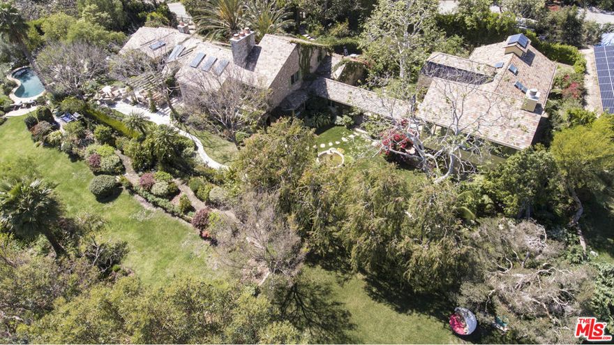 A Stunning Point Dume Retreat! Experience the South of France in Malibu. This gated Point Dume estate offers private access to the coveted Little Dume Beach, combining European romance with California coastal luxury. Behind the gates and towering hedges, awaken to ocean views, rolling green lawns, and an abundance of fruit trees and flowering gardens. Meandering stone walkways and waterfalls lead to a sun-drenched pool framed by two Monet-inspired ponds alive with lilies, fish, and songbirds.As evening falls, panoramic vistas of the Queen's Necklace shimmer beyond outdoor fireplaces and trellised dining patios. Thoughtful landscape lighting highlights the French stone faade and serene ambience of this private retreat.Inside, reclaimed hardwood floors, Venetian-plastered walls, and four artisan-crafted wood-burning fireplaces create warmth and character. Expansive windows and soaring ceilings invite natural light and garden or ocean views into every room. Vintage lighting, one-of-a-kind antique doors, and a chef's kitchen with top appliances pair modern convenience with timeless style. Each bedroom suite opens onto a private deck, providing the ultimate in privacy and luxury. Whether enjoying morning coffee among the gardens, a swim beneath Malibu's golden sky, or an alfresco dinner under the stars, Provence en Malibu offers an unforgettable blend of elegance, tranquility, and seaside charm.