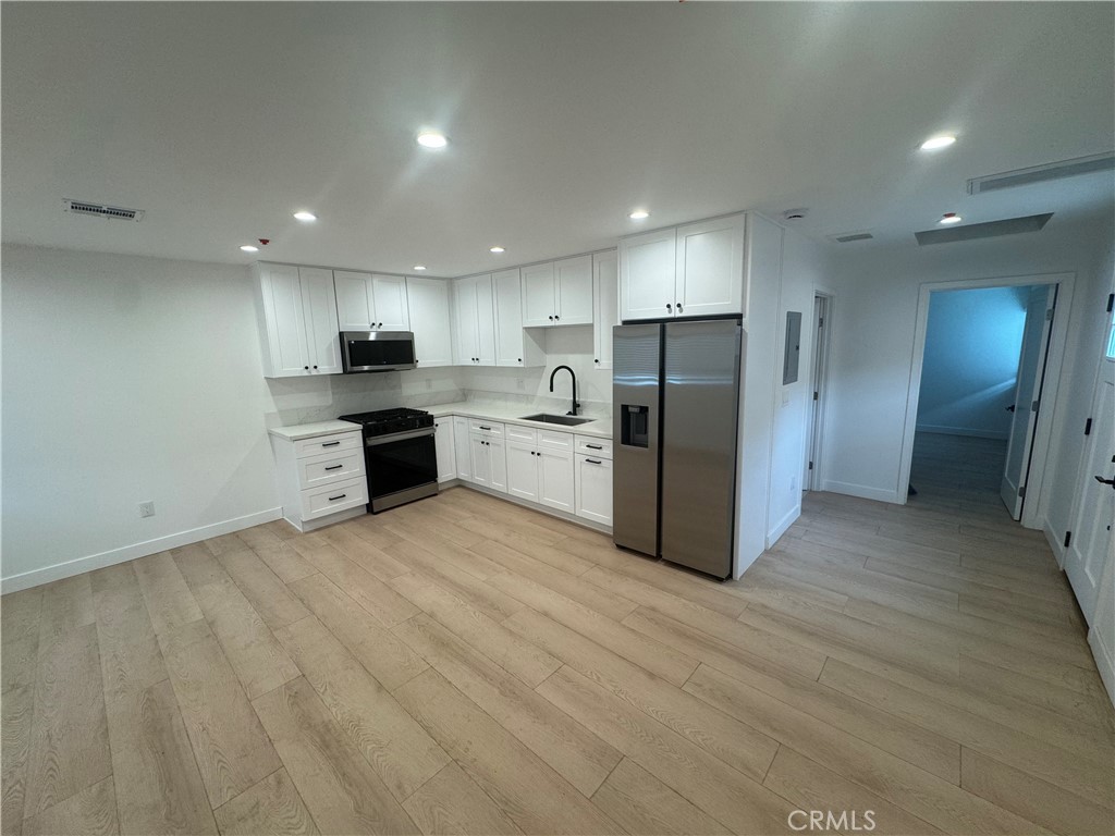 Step into this beautifully updated 1 bed, 1 bath garage conversion featuring a modern design and high-end finishes. With brand new plumbing, electrical, and recessed lighting, this unit is move-in ready. The kitchen shines with quartz countertops, new cabinets, and brand new appliances including a refrigerator, microwave, and stove/oven. Luxury flooring adds a refined touch to this stylish space.