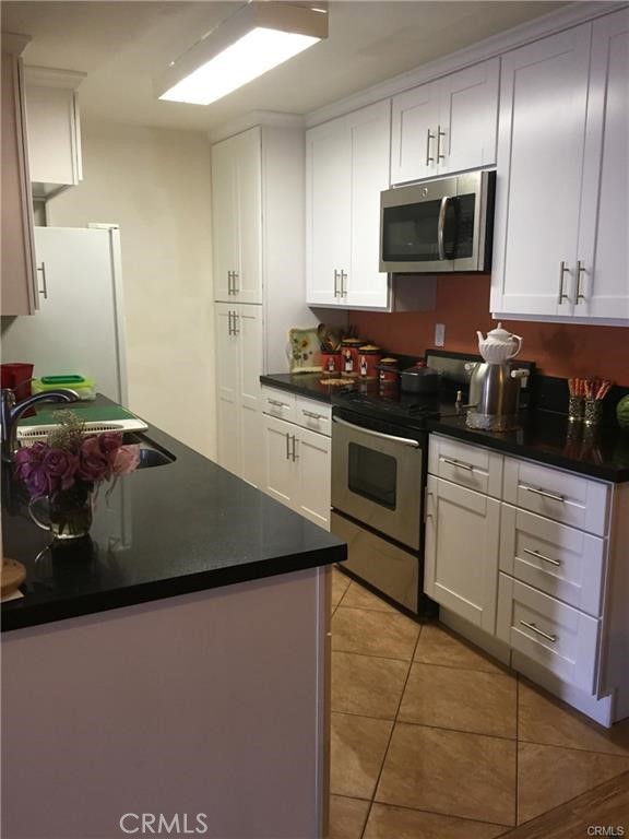 Rare opportunity, total privacy, top floor, corner unit with no common walls in the resort-style living of Encino Villas. Unit features wood floors, fireplace, a wet bar w/ white cabinets in the living room and lots of closet space. The 2 bedrooms are separated by the living area, and each has its own bathroom. Fully renovated kitchen with black quartz countertops, white cabinets and stainless steel appliances. Unit has Central Cooling and Heating! This unit has two (2) side by side parking spaces in a gated and covered garage and a large balcony. HOA dues of $483/month! Complex was completely renovated few years ago with lush landscaping, pool, spa, recreation room, gym, sauna, game room, grills and lounge area. Conveniently located at the heart of Encino close to Ventura Blvd with all the fabulous restaurants and stores that Encino has to offer.