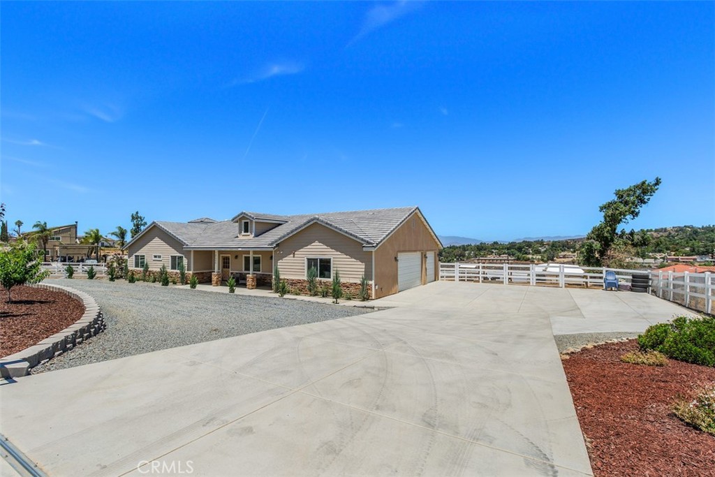 Gorgeous custom three bedroom , two and one half bath single level ranch home. Open great room concept with panoramic city lights, mountain views. Gourmet kitchen with granite counters, large island with prep sink, stainless steel appliances and farm style sink. Built-in wine fridge. two ovens. Walk in pantry. Ceiling fans. Oversized laundry room with sink. Separate powder room. Primary suite with sliding doors leading out to oversized deck running the width of the home. Spa inspired primary bathroom with separate stand alone soaking tub and walk in shower. Two generous sized secondary bedrooms. Three car attached garage with epoxy sealed floors.220 in the garage. RV hook up 30/50 amp and sewage. Manicured front grounds including fruit trees, apple, peach, pomegranate, plum and pear. Shedrow barn with 4 stalls and attached feed room. 48 x 24 turn out stall. Gated property. This home is a must see to appreciate.