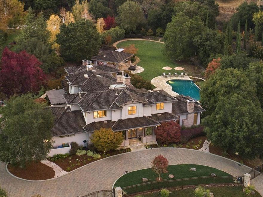 This stunning home was built by Pacific Peninsula Group at Quarry Lake, a tucked-away enclave of prestigious homes surrounding the lakeside setting. Spanning more than one acre with resort-inspired amenities as well as lake access, this gated home offers a lifestyle of luxury and privacy in a rare setting. Classic and timeless finishes extend throughout- refinished hardwood floors, refined millwork, slate, marble, and honed limestone and granite finishes. Located on a non-through street, this magnificent 5829 sf home has 5 BD/4BA, 2 powder rooms, executive study, tremendous kitchen and step-down formal living room. The outdoor amenities include an infinity-edge pool and spa, fireplace terrace, separate barbecue terrace, plus putting green, BB court (with regulation keys), soccer-worthy lawn. Adjoining is a vast heated entertainment pavilion w/outdoor kitchen, which includes barbecue, sink with hot water and disposal, Sub-Zero refrigerator, and ample cabinets, along with a half-bath.