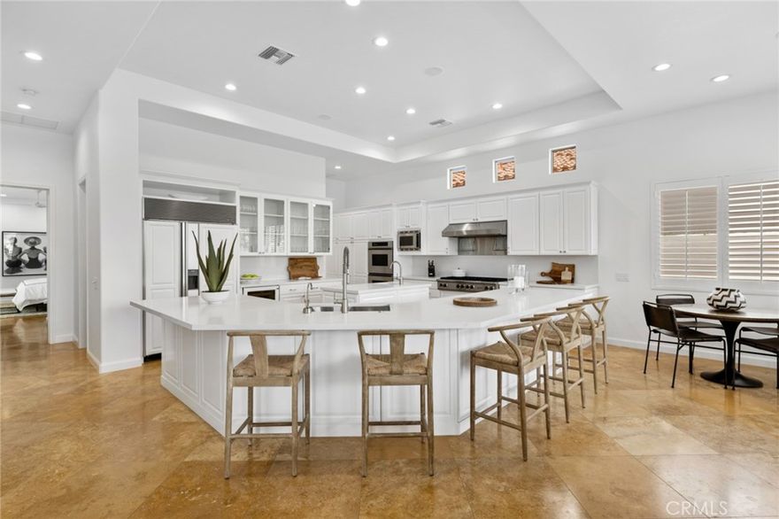 This completely outfitted, open-concept design exudes California chic throughout its 4-bedroom, 5-bathroom single-level floor plan. Comfort and unsurpassed style elevate the guest experience overlooking the second fairway on the nearly 15,000-square-foot private parcel in the guard-gated community of the Citrus Club. The desert lifestyle continues as you enter the fully equipped and remodeled chef’s kitchen featuring crisp white cabinetry, quartz counters, and a complete stainless-steel solution from Thermador and Viking. A center island and ample bar seating are ideal for the chef who enjoys socializing while preparing meals. Dining accommodations include a formal dining room, breakfast nook, patio seating, and a covered loggia with Infratech outdoor heating. This remarkable property boasts an extensive amenity list and numerous building system upgrades, including Samsung TVs, Roku video streaming, Sonos surround sound, iPad & Wi-Fi controls, whole-house audio, a pool, spa, billiards room with a wet bar, and fiber internet. Centrally located by the La Quinta Resort, PGA West, Polo Fields, Indian Wells Tennis Gardens, and only a short distance to El Paseo or downtown Palm Springs.