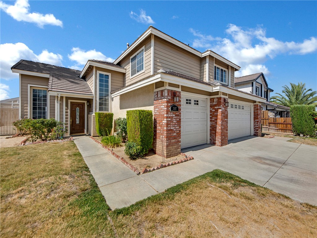This beautiful home is located in the sought after Boulder Ranch community. This community is located right off the 14 freeway and Pearblossom highway which makes it ideal for commuters who drive south to Los Angeles or north to our booming aerospace industry. The home features a three car garage, plenty of parking space on the driveway, modern grey tile roof and red brick accents. As you walk into the home you are greeted with high ceilings, lots of natural light in the large living room through the dual pane windows, new modern lighting, laminate flooring & new paint throughout. The upgraded kitchen is open to the breakfast nook & a family room with a fireplace is on the right. The Kitchen features all new stainless steel appliances, Calacatta marble design quartz counter tops, recessed lighting and modern faucet and sink combo. Downstairs features a full bathroom & bedroom, laundry room & direct access to the garage. Upstairs has a spacious hallway with linen closet & quartzite counter top, a master bedroom, master bathroom, three more bedrooms & a third full bathroom in the hallway. The Master bedroom has vaulted high ceilings, recessed lighting, two large walk-in closets, & a master bath that includes a stand up shower, bathtub, dual sink vanity, modern faucets & tile flooring. The master bedroom has breath-taking views of the antelope valley. The backyard is spacious with a covered concrete slab patio, large storage shed, driveway for parking RV's, boats and toys, & open space for entertaining. The home has a Smart Nest thermostat and dual pane windows making it energy efficient.