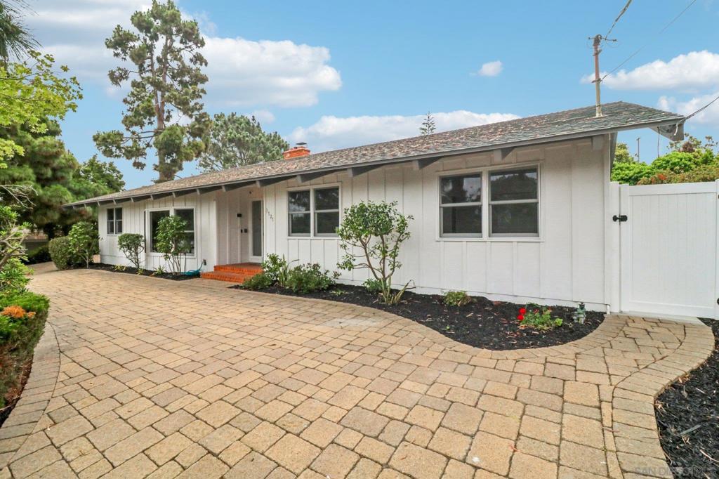 Coastal Elegance in Point Loma’s Wooded Area! Tucked away on the final residential street off Catalina Blvd, this updated 4-bedroom, 3-bath home captures the essence of serene coastal living with thoughtful design and timeless style. Set on an expansive 12,000+ sq ft lot, this sanctuary has been completely refreshed and in impeccable move-in condition. Features include a brand-new coastal-inspired kitchen, soft-close cabinetry, generous storage, a sun-drenched living room with vaulted ceilings, large skylights, and a dramatic fireplace. A spacious family room with a second fireplace is perfect for relaxing or entertaining. The bathrooms have been remodeled with spa-like finishes and designer touches. There is a tranquil primary suite with vaulted ceilings and leafy garden views, there is a formal dining room for gatherings, and a separate laundry room with new appliances. There is all-new flooring, lighting, ceiling fans, and fresh paint inside and out. Outside is a lush, private backyard—fully fenced, secure, and bordered by a quiet Naval Base parking lot, offering privacy and peace. Additional features include owned solar panels (no lease!), plumbing for solar water heating, an oversized 2-car garage with extra space for a workshop or storage, a circular driveway and ample off-street parking. Enjoy the best of coastal San Diego just minutes away: Cabrillo National Monument, Fort Rosecrans, yacht clubs, beaches, fine dining, San Diego International Airport, and the vibrant downtown waterfront. This neighborhood is extremely unique and quiet, the backyard shares a boundary line with a Naval Base parking lot; therefore, the home and yard are incredibly quiet and very secure. All appliances convey to the new owner. Public records show this as a 4 bedroom home, currently one bedroom is currently configured as an office, closets can easily be added.