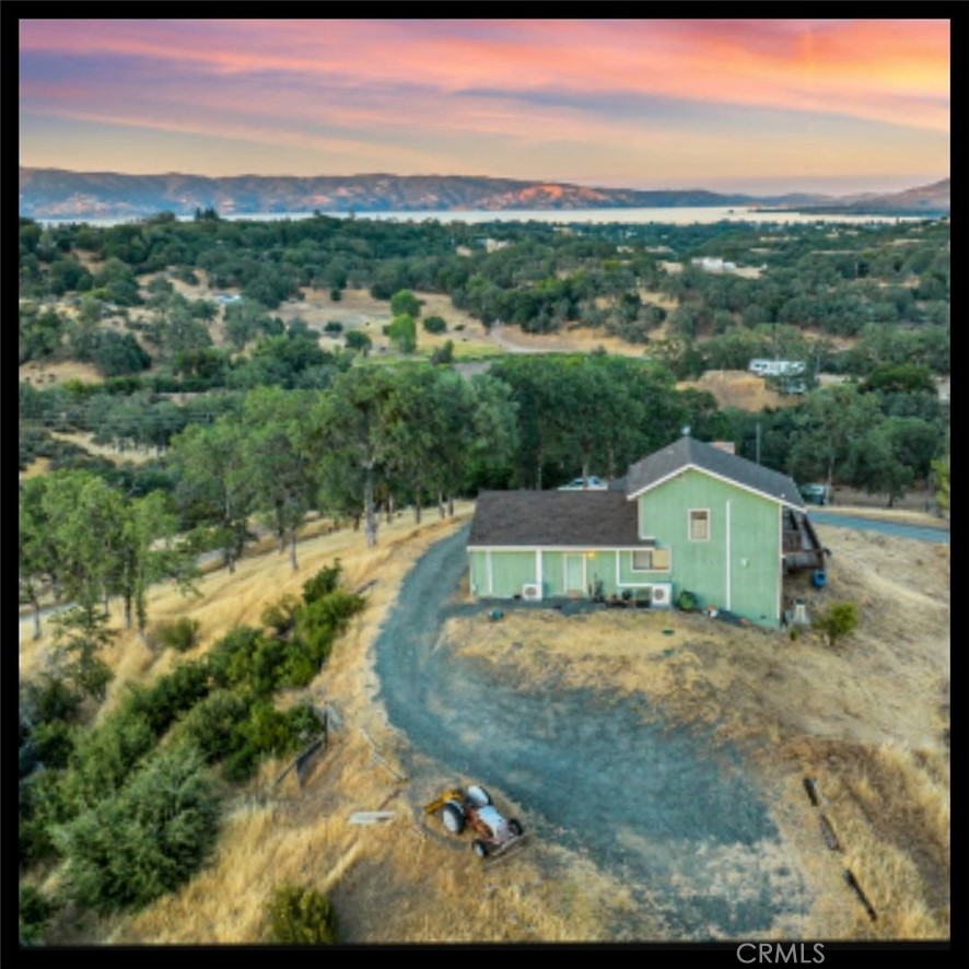 Amazing views on 10 ± ACRES in Lakeport! Gorgeous mountain and lake views. Unique opportunity to own in one of Lake County's most sought-after neighborhoods and only 10 minutes to downtown Lakeport and shopping. Turnkey home complete with high speed STARLINK internet ready for you and your animals to move right in! Recent updates include a new roof, new well pump and energy efficient mini split systems for heating/air. 3BED/2BATH plus bonus room with a closet that could be used as an office or 4th bedroom. Open concept living area with vaulted wood beam ceilings and real wood fireplace. Kitchen has been updated with stainless steel appliances, painted cabinets and galvanized metal and wood accents. The bedrooms are thoughtfully placed and are all separated from each other in different areas with the private primary suite upstairs and includes an ensuite bath and its own private deck. Secondary living area that can be enjoyed as a sitting area, formal dining room or playroom. The finished attic area is accessible from the main living space and is perfect as an extra storage area. Many updates have been done through the recent years including installation of a transfer switch for power shutoffs, graveled driveway, booster pump for water system, siding has been redone, interior/exterior paint and new septic system. Fenced corral with shade structure making it a great turnkey horse property, 4-H property for the kid’s animals, or just perfect for the buyer looking for some space or room to grow at an affordable price! Pictures are digitally staged