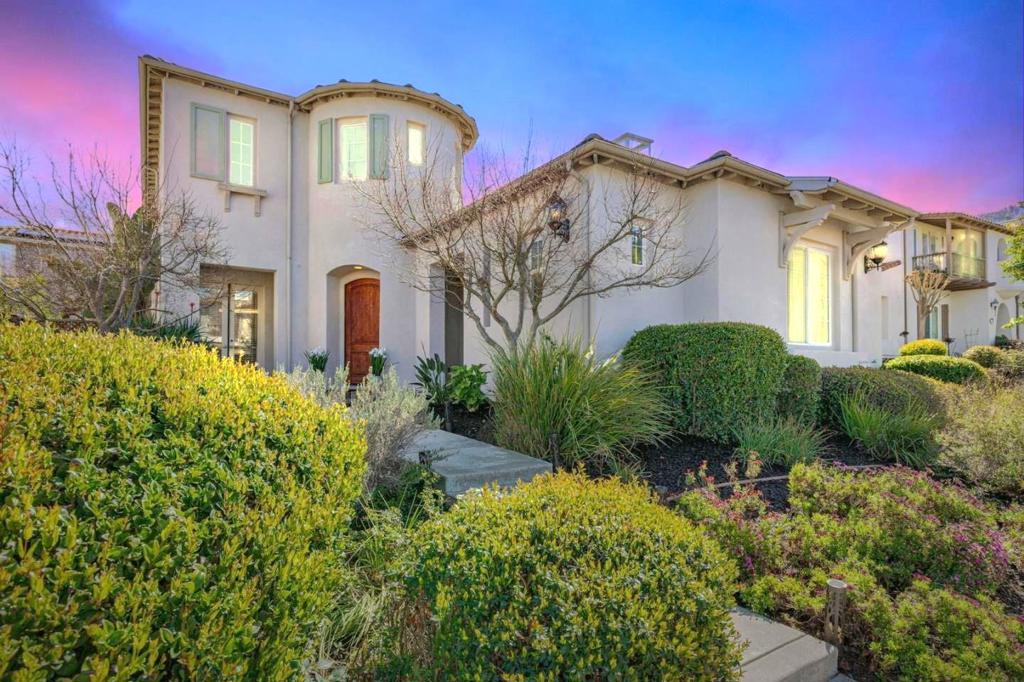 ***Stop searching*** This is the one! Welcome to this stunning home in the prestigious, gated golf course community of Eagle Ridge. Boasting 3,688 sq. ft. of living space on a generously sized lot, this 5 bedroom/4.5 bathroom home offers a perfect blend of comfort and style. As you enter through the impressive turret entry, you'll be greeted by rich hardwood floors that flow seamlessly throughout the home. The family & living rooms, each with its own fireplace, are designed to open up to a private courtyard with bistro lighting ideal for both relaxation & entertaining. There is a beautiful formal dining room and well-appointed kitchen featuring gorgeous granite counters, double ovens, and center island with sink. The main level has TWO bedrooms with ensuite bathrooms one of which is an attached casita with its own entrance, perfect for extended family or that new graduate! Upstairs you will find 3 additional bedrooms, 2 of which have their own balconies, including the primary suite, offering views of the surrounding mountains. The Primary suite is a true retreat, with a jetted tub, oversized stall shower, balcony, and plenty of space to unwind. The two-tiered flagstone backyard is perfect for outdoor entertaining with beautiful landscaping and an area for a garden. Welcome home!