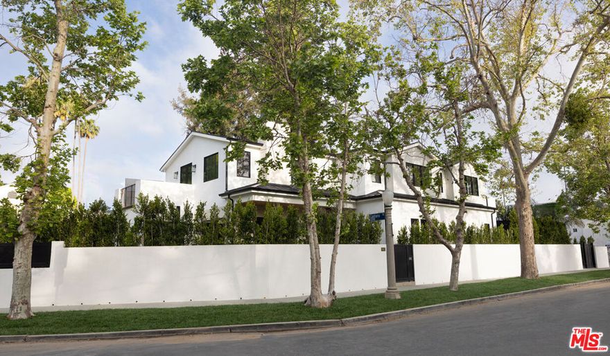 Nestled in the heart of Studio City's most coveted enclave, The Silver Triangle, this one-of-a-kind newly constructed estate masterfully blends classic traditional architecture with refined modern design. Built with the utmost attention to detail, every element of this home reflects a perfect balance of sophistication, warmth, and high-end functionality.  A dramatic entrance with soaring ceilings and a striking open staircase sets the tone for the exceptional craftsmanship found throughout. Sun-drenched living spaces create a welcoming ambiance ideal for both intimate gatherings and grand-scale entertaining.  Designed for the most discerning homeowner, the residence features a state-of-the-art lower level complete with a private movie theater, steam room, fully equipped home gym, bespoke wine cellar, and full bar. The gourmet kitchen is a culinary dream, enhanced by a secondary prep kitchen/mudroom ideal for entertaining or catering.  This ultra private home office offers peaceful garden views, while the backyard retreat is equally impressive highlighted by a luxurious resort-style salt water pool and spa, a spacious pool house with full bath, and a covered dining pergola featuring a custom rainfall water feature for added serenity.  This rare offering combines ultimate luxury, privacy, and convenience. Just moments from Ventura Boulevard's renowned shops and restaurants, yet tucked away in a serene, tree-lined neighborhood. Discover the pinnacle of modern living in one of Studio City's finest new homes.