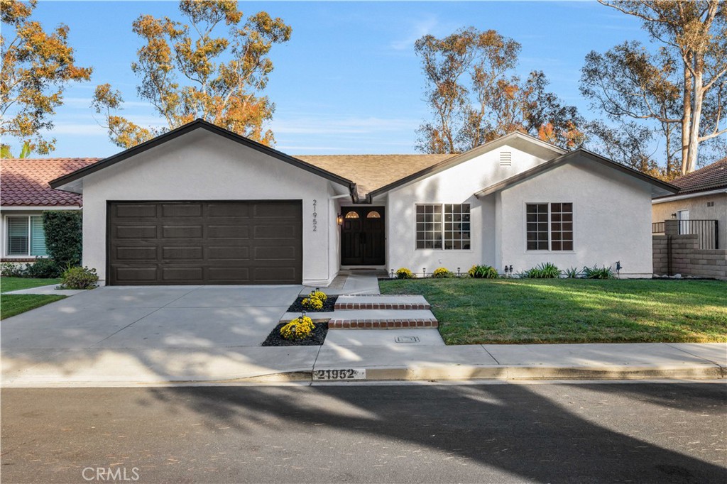 This beautifully renovated single story home sits on a quiet cul de sac in Mission Viejo and perfectly blends modern upgrades with style and functionality. Every detail has been thoughtfully designed, from energy efficient systems to designer finishes, making it a truly move in ready residence.
Inside, high end waterproof hybrid laminate flooring flows seamlessly throughout, accented by modern baseboards, fresh paint, updated outlets, switches, hardware, and energy efficient LED recessed lighting. The fully remodeled gourmet kitchen showcases custom white and oak Shaker cabinetry with soft close drawers, quartz countertops with a full height backsplash and waterfall edges, ceiling height cabinets, touchless sink with pot filler, and professional grade appliances including a 36" 6 burner Thor gas range, Thor drawer microwave, Thor wine fridge, GE Profile double drawer dishwasher, Samsung refrigerator, and sleek range hood. An elegant farmhouse chandelier and updated fireplace bring warmth to the family room, while new hallway cabinetry and a high capacity washer dryer with overhead storage add convenience.
The primary suite offers a spa like retreat with a walk in shower featuring oversized shampoo niches, double vanities with quartz counters, soft close cabinetry, and upgraded fixtures. All bathrooms have been fully remodeled with modern cabinets, countertops, faucets, mirrors, and low flow toilets. Each bedroom has new flooring, baseboards, paint, and lighting for a fresh, modern feel. Additional smart home features include a Nest thermostat, Ring camera doorbell, and a full PEX repipe for added peace of mind.
The private backyard is fully enclosed, perfect for pets and children, and offers serene mountain views with no neighbors behind. A stylish maintenance free privacy fence with lush greenery enhances the outdoor living space. The finished two car garage has been freshly drywalled, painted, and upgraded with epoxy flooring.
Residents also enjoy exclusive access to Lake Mission Viejo, featuring sandy beaches, swimming, boating, fishing, a clubhouse, and year round events. With no Mello Roos, a low HOA, and a prime location, this turnkey single story is a rare opportunity in one of Mission Viejo’s most sought after neighborhoods.