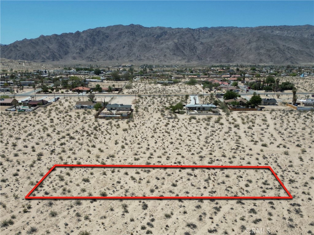 This gorgeous parcel of land is almost 3/4s of an Acre and deep within the Mohave Desert . Own a piece of the "Oasis in the Desert"! There's an Easement on this property done by Southern Pacific Land Co for Railroad and telephone lines to access. This is noted on the Preliminary Title Report. There's a photo to show it's drivable too. This land is private and affordable! There are homes nearby. Need room to spread out you've just found it. Property has unobstructed views of the mountains everywhere you look! 29 Palms CA is known throughout the world for it's Star Observatory. This is one of the most beautiful places to look up at the galaxy and constellations, stars seem close enough to touch. This is absolutely breathtaking views ! No doubt this is the perfect opportunity to live off the GRID with the GALAXY as your neighbors! It's less than 30 minutes drive for vast shopping experiences, there's speciality dining all along Highway 62 as well. Joshua Tree National Park for hiking enthusiasts that exit is just minutes away. The road to this property is Manana Drive and it's not paved. A truck or an ATV type vehicle for access. The sign is located on the South East corner of Manana Drive. Do come and take a look sooner than later, we are accepting all offers!