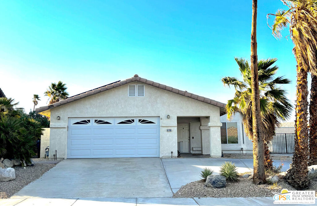 Welcome to your desert oasis in the heart of Cathedral City! This beautifully updated single-story home is move-in ready and packed with desirable features. Enjoy vaulted ceilings, an open-concept floor plan, and brand-new wood flooring throughout the main living areas. New carpet in the bedrooms adds comfort where it matters most. The kitchen shines with tile counter tops, stainless steel appliances, and abundant cabinet space-perfect for everyday living and entertaining. The cozy living room features a gas fireplace with glass doors, adding warmth and charm. Step outside to your private backyard retreat with a pebble-tec pool and spa, built-in BBQ, and open patio. RV owners will love the gated side parking area with full hookups including water, sewer, and power-measuring over 60 feet deep! Additional highlights include central A/C, an attached 2-car garage, automatic sprinkler system, and tile roof. Located on a quiet interior street in the desirable Rio Vista neighborhood with no HOA and no land lease-you own the land! This home checks all the boxes-schedule your showing today before it's gone!