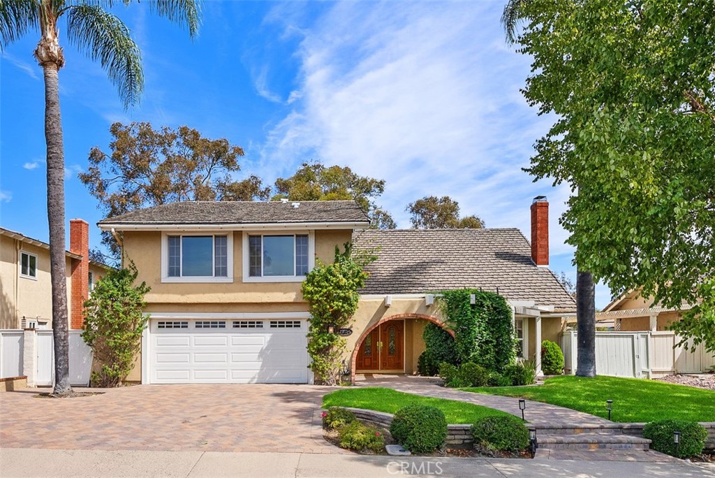 Welcome to this beautifully maintained home in the highly desirable La Paz community of Mission Viejo! From the moment you arrive, you’ll be impressed by the paver driveway and charming front courtyard that lead to a dramatic double-door entry. Inside, the spacious foyer, soaring ceilings, and elegant staircase set the tone for this light-filled and thoughtfully designed home. To the right, the formal living room features vaulted ceilings and a cozy fireplace, seamlessly flowing into the dining area with French doors that open to your private entertainer’s backyard. The heart of the home is the chef’s kitchen—an absolute dream with Omega custom cabinetry, a large island with prep sink, built-in gas cooktop, warming drawer, double ovens, built-in refrigerator, microwave, and dishwasher. A wall of cabinetry, small desk area, and attached breakfast nook/table provide abundant functionality. The kitchen overlooks the serene backyard and opens to the inviting family room with fireplace and additional French doors for indoor-outdoor living. Downstairs also includes a powder room and an incredible bonus storage room with more cabinet space and a large wine refrigerator—perfect for your bulk Costco storage. Upstairs, the expansive primary suite offers sweeping views of trees and mountains. The luxurious ensuite bath features a soaking tub, walk-in shower, private water closet, dual sink vanity, and a massive walk-in closet. Also upstairs, you’ll find a beautifully designed laundry room with sink and ample cabinetry, making laundry tasks both convenient and organized. Three additional upstairs bedrooms include a Jack & Jill bedroom setup with a shared bathroom featuring a tub/shower combo and dual sink vanity, and a fourth bedroom with its own private ensuite bath with walk-in shower. Step outside to a peaceful backyard retreat with lush lawn, spacious patio with multiple seating areas, and beautiful views—ideal for entertaining or unwinding. Just a short walk to award-winning elementary, middle, and high schools, Montanoso Rec Center, Oso Creek Trail, Mission Viejo Library, Saddleback Lanes, Mission Viejo Farmer’s Market, Trader Joe’s, Yoga, Pilates, endless shopping, dining, and more! Enjoy the OPTION to join Lake Mission Viejo with boating, swimming, fishing, concerts & events. This impeccably maintained home offers the perfect blend of comfort, convenience, and California lifestyle. Welcome Home!