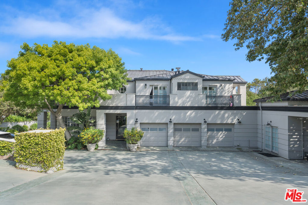 Experience coastal luxury in this beautifully designed, light and bright, private double-gated estate located in the heart of Malibu's coveted Point Dume neighborhood. This expansive retreat offers exclusive Riviera 1 beach key access via the Zumirez gate, complete with dedicated beach parking and toy storage and unmatched convenience for Malibu living. Spanning approximately 8,000 square feet over two separate residences, showcasing soaring 18-foot ceilings, gallery-style walls ideal for art, and a sunlit living room with a fireplace. The chef's kitchen is built for entertaining and flows seamlessly into multiple formal and casual living spaces, including a spacious office/library and gym. Upstairs, each bedroom opens to its own private balcony with tranquil treetop views. The primary suite features dual bathrooms and generous closet space. The estate sits on over an acre of flat, park-like grounds with mature gardens, a secluded swimming pool off the family room and kitchen, and a fully equipped outdoor kitchen perfect for hosting gatherings in a serene setting. Ample gated parking and a dual-entry motor court accommodate numerous vehicles and valet service with ease. Located on the property is a two-story guest house offering an additional two bedrooms and two bathrooms, its own two car garage for guests or staff, or as a studio, gym, or creative space. Additional features include solar power and recycled water systems for almost zero utility cost, a three-phase EV charging station, and a sustainable lifestyle without compromise. Point Dume neighborhood offers a timeless sense of community and tranquility. From surfing to leisurely strolls through the nearby nature preserve overlooking Big Dume Beach, every day presents an opportunity for adventure and relaxation. Embrace the ultimate in coastal living where every moment feels like a vacation.