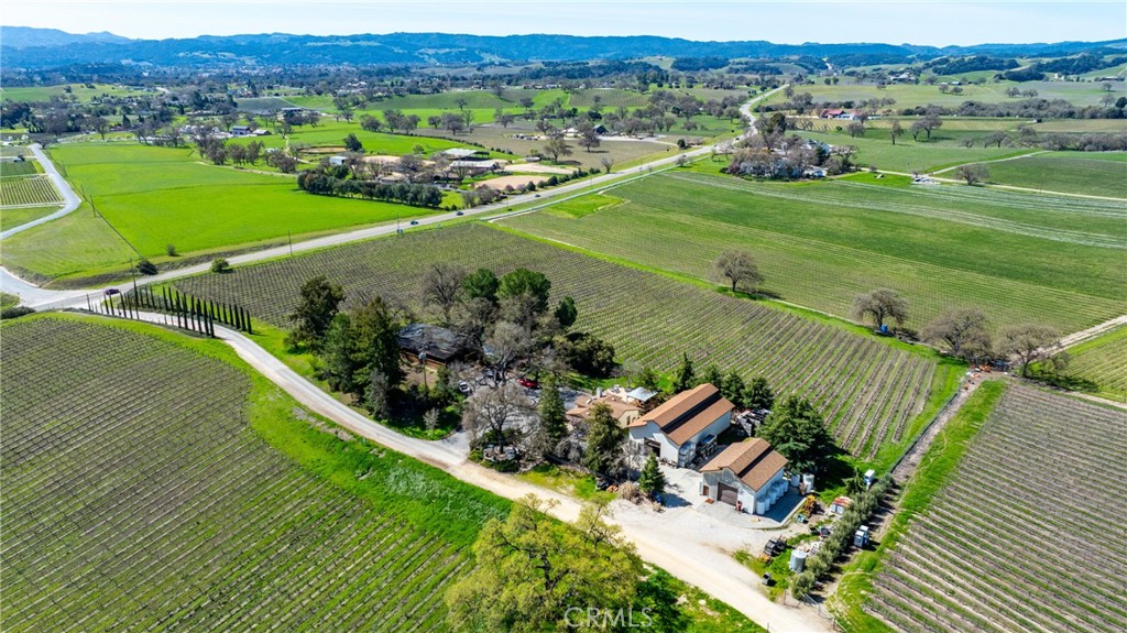 This is a fantastic opportunity to purchase one of the first wineries and tasting rooms along Highway 46 West, nestled within the Templeton Gap AVA. This 40-acre estate fronts Highway 46 West, with 36 acres planted with Malbec, Cabernet, Barbera, Merlot, and other varietals.
The improvements include a residence, tasting room, production and storage buildings, and beautifully cultivated vineyards along the scenic highway. The 2,100-square-foot residence is also situated on a knoll, providing stunning views of West Templeton and the Santa Lucia Mountains. This three-bedroom, two-bath home features an open-concept living area, a stacked stone fireplace, engineered reclaimed barn wood flooring, and much more. The 12' x 60' deck is an excellent outdoor entertaining space.
Some believe this location served as the headquarters for the original Spanish land grant, though that remains unconfirmed. The winery has been operational for approximately 27 years and has a use permit for a 15,000-case capacity. The tasting room is about 1,100 square feet, complete with a bar area, retail space, and an ADA-compliant bathroom.
Outside, you will find two insulated production and storage buildings featuring a backup generator, measuring approximately 2,500 square feet and 1,280 square feet, respectively. The property has an 8-inch well with a 30-horsepower variable pump, a filtration system, and an irrigation well. The additional three legal parcels each have wells that are not currently in use.