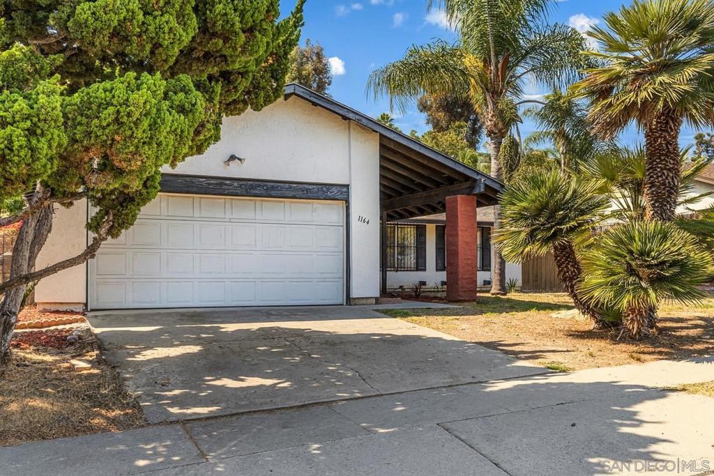 Nestled in one of Southeast San Diego’s most welcoming, family-friendly neighborhoods, this home sits on a rare 0.4-acre lot — a true gem within city limits. Here, you’ll find kids riding bikes and neighbors gathering at the nearby community park, just a short walk away. Inside, a bright and airy layout greets you with fresh interior paint, brand-new carpet, and updated flooring that seamlessly blends comfort and style. The kitchen features a new dishwasher, making it as functional as it is inviting. Multiple spacious bedrooms offer private retreats for everyone, while the bathrooms shine with new vanities that bring a modern touch. Generous living areas flow easily from room to room, perfect for everything from casual mornings to lively get-togethers. But the real showstopper? The land. Nearly half an acre of space opens the door to endless possibilities — create your dream garden, design a peaceful hilltop escape to soak in the views, or simply let kids and pets roam free. It’s the rare combination of privacy, space, and city convenience — close to shops, schools, and major freeways. If you’ve been searching for a home that feels like yours from the moment you arrive — with room to grow, play, and connect — this is it.