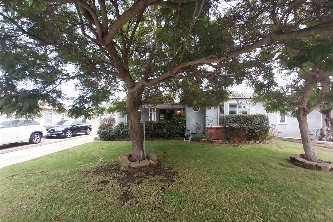 Welcome home to this beautiful 2 BD and 1 BA house on a tree-lined street located in a highly-desired neighborhood. The kitchen features classic cabinets and tiled counters next to a convenient laundry closet. Relax in the bedrooms with large bay windows and shutters that let in lots of light. Gorgeous updated bathroom has a glass shower door and granite vanity sink. This home has handsome exterior brick trimmings and amazing greenery including avocado and lemon trees that provide plenty of privacy in addition to the brick-wall fencing. This well-maintained home with real hardwood floors is a great space to entertain. Enjoy an abundance of parking options with a long driveway, 2-car detached garage with remote, and additional street parking. Convenient to Loyola Marymount University, Westchester Golf Course and Recreation Center, 405 FWY, groceries, shopping, and more! Schedule a showing today!