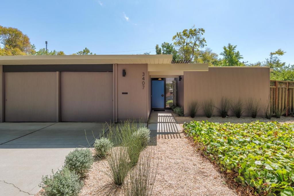 Designed by renowned architect Joseph Eichler, this move-in ready residence sits on a spacious corner lot and showcases signature Eichler details throughout. Post-and-beam construction, an open floor plan, and walls of floor-to-ceiling glass create seamless indoor-outdoor living that defines the mid-century modern aesthetic. The main living spaces flow effortlessly, perfect for both entertaining and everyday living. A dramatic brick-and-tile fireplace anchors the elegant living room, while the adjacent dining area sets the stage for memorable gatherings. Glass doors open to multiple outdoor patios, blending the homes interiors with its serene surroundings. The private bedroom wing includes a primary suite with a refreshed en-suite bath, three additional bedrooms, and a convenient laundry area. Modern comforts such as radiant floor heating, new carpet, and an attached two-car garage enhance daily life. Mature, low-maintenance landscaping frames the property, offering multiple areas to relax or dine al fresco, from the redwood deck to the peaceful back patio. This home captures the essence of Eichler design: minimalist yet inviting, architecturally significant yet highly livable. Located in a highly sought-after neighborhood near top-rated Palo Alto schools, shopping, and dining.