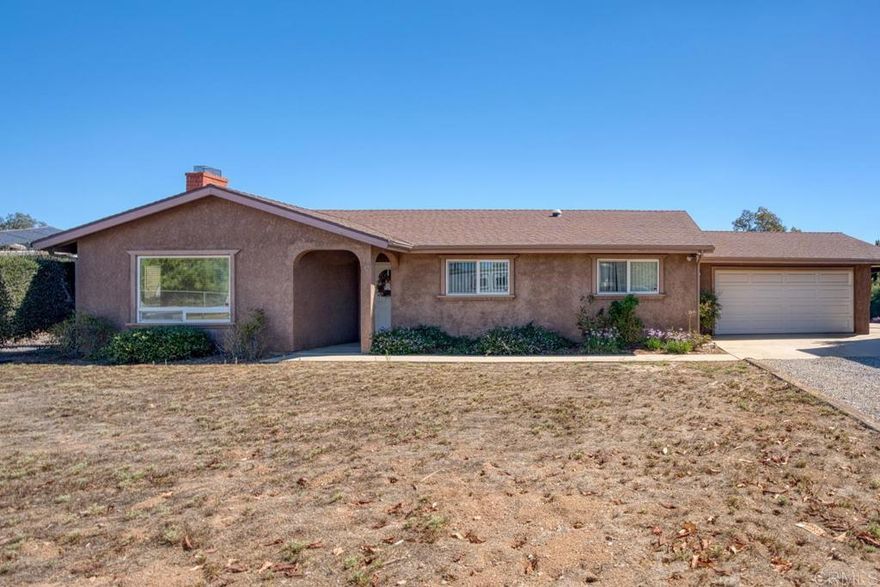 Welcome to this beautifully upgraded property, thoughtfully designed for comfortable living and equestrian or animal use. This home and ranch-style setting combine modern amenities, energy efficiency, and extensive outdoor features.  Inside, the home boasts custom-built bathroom cabinetry with maximum storage, and elegant travertine countertops. The kitchen is enhanced with granite tile counters, a brand-new refrigerator, microwave, and a spacious pantry complete with ShelfGenie pull-out drawers and organizers. Dual-paned windows, a who house vacuum system, a newer water heater, a new heater, and a Mirantec garage door opener with a newer garage door ensure both comfort and efficiency.  Energy features include 26 solar panels, 2 Tesla Powerwalls, a Tesla EV charger, and a new Lopi wood-burning stove, offering sustainable living without compromise. A home security system adds peace of mind.  Outdoors, the property is fully fenced and cross-fenced with a powered front gate. Equestrian enthusiasts will love the impressive 108-ft steel beam custom horse structure, 6 oversized 24x24 corrals, an additional 12x24, a 54-ft round pen for exercising, 2 wash racks/grooming stalls, and a hay barn with electricity. A 12x10 wood shed/tack room adds convenience.  The backyard is perfect for entertaining or relaxing, featuring a covered patio, a sparkling above-ground 3-5-3 pool with a new upgraded variable-speed pump, and raised garden beds for your seasonal plantings. Mature fruit trees—olive, grapefruit, lemon, tangerine, lime, avocado—and blackberry vines provide an abundance of fresh produce right at home.  The roof was completely redone in 2009, and plumbing extends throughout the property, making every corner functional.  This unique property offers a rare combination of modern upgrades, energy independence, and equestrian amenities, creating a private retreat with everything you need.