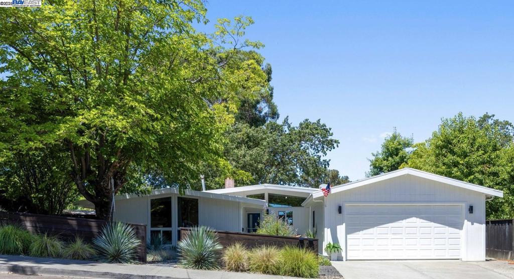 Step into this show-stopping Midcentury-Inspired 3BD/2BA masterpiece, just blocks from Downtown Pleasanton! Thoughtfully renovated with style and function in perfect harmony, the open-concept kitchen and family room are the true heart of the home—drenched in natural light and designed to impress. The chef’s kitchen blends modern sophistication and retro charm with white high-gloss uppers, rich textured lowers, brass hardware, a bold blue ombré tile backsplash, stainless appliances and a professional-grade ZLINE range. A stunning oversized island with seating for five is perfect for casual gatherings or morning coffee, topped with quartz counters and a butcher block accent station for added warmth and texture. Pendant globe lights float elegantly above, adding midcentury flair and ambient glow. Open beam ceilings, warm wood-tone flooring, and striking design elements make this home an entertainer’s dream. Natural light from the large windows and sliders create a seamless flow to the private backyard oasis, featuring a cozy patio, deck, zen garden, and a newly resurfaced pool—perfect for indoor-outdoor living. Situated on a quiet court with thoughtfully designed drought-tolerant landscaping, this home offers curated comfort inside and out. You’ll never want to leave!