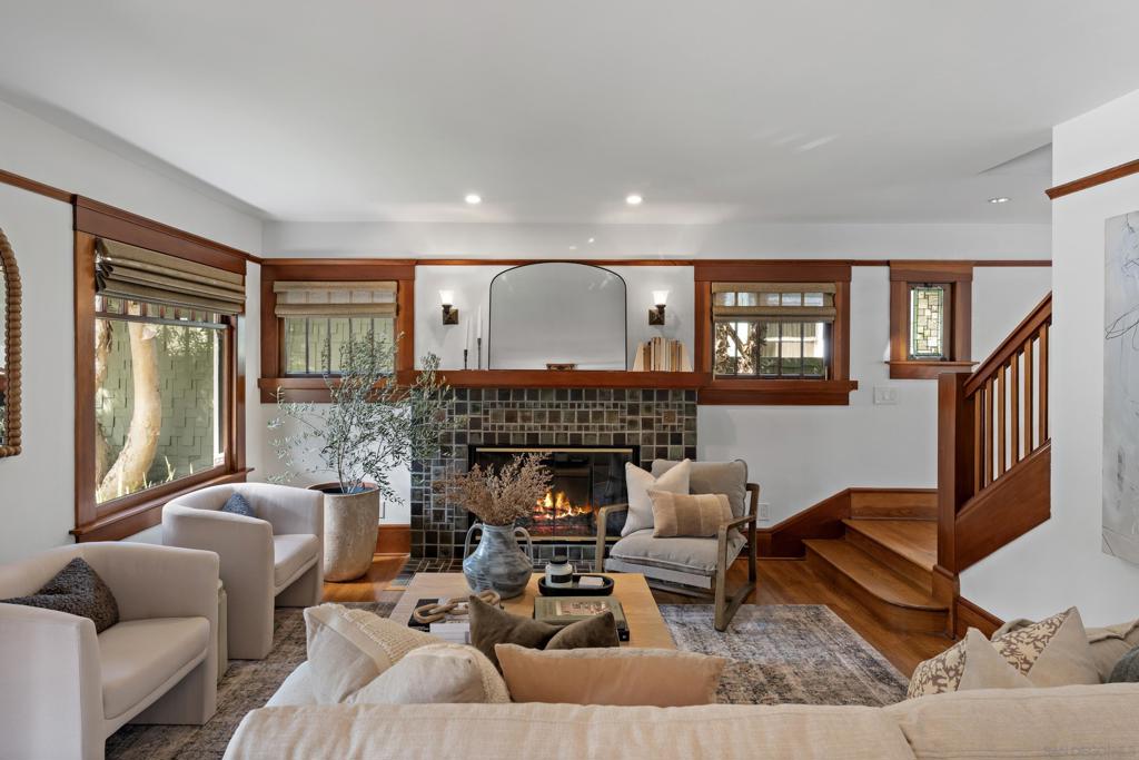 Perched gracefully on a quiet canyon in coveted Mission Hills, this 1911 Craftsman masterpiece blends timeless architectural heritage with thoughtful modern upgrades, offering more than 3,000 square feet of living space. Designed with extraordinary versatility, the home features 3 bedrooms, 2.5 baths, and four additional bonus rooms ideal for a home office, children’s den, craft studio, or additional bedrooms/bathrooms. Steeped in architectural legacy, this residence is intrinsically connected to one of California’s most esteemed preservation architects, Milford Wayne Donaldson who served as the California State Historic Preservation Officer and was later appointed by President Barack Obama as Chairman of the Advisory Council on Historic Preservation. Once serving as the headquarters of his distinguished practice, the home reflects Donaldson’s enduring vision of uniting historic craftsmanship with modern innovation. Inside, the entry level welcomes you into an elegant living room and a formal dining space that flows seamlessly into an additional family room and kitchen. The chef’s kitchen is a true showpiece, appointed with Mont Blanc Quartzite countertops, rich hardwood floors, a Miele dishwasher, and a generous walk-in pantry. A charming powder room and direct access to the garage complete this level, balancing style with everyday convenience. The lower level reveals a serene primary retreat with a spa-inspired ensuite bath, dual walk-in closets, and direct access to a private enclosed patio where a seven-person hot tub overlooks tranquil canyon vistas. A spacious 30’ x 13’ finished basement enhances the home’s versatility, well-suited for a game room, additional bedroom and bath, or creative studio, while a luminous sunroom invites quiet moments of relaxation. A newly reimagined office with craft area and an expansive laundry room with abundant storage complete this level. Upstairs, two jack-and-jill bedrooms share a light-filled bath, complemented by a flexible loft-style space that easily adapts as a playroom, study lounge, or reading nook. Outdoor living is reimagined with more than 890 square feet of two sweeping wood decks, offering a breathtaking setting for both grand entertaining and serene mornings above the canyon. The grounds are meticulously curated, from the velvety expanse of Korean grass along the front yard to the lush, low-maintenance turf in back, all enhanced by tiered landscaping, a thoughtfully engineered retaining wall, and fully automated irrigation that ensures effortless beauty in every season. An oversized spa crowns the setting with an indulgent, resort-like ambiance. Meticulously maintained and thoughtfully upgraded, the home includes Owens Corning roof shingles installed in 2019 with a 50-year warranty, along with classic wood windows, durable composite siding, and the convenience of an EV charging station. Eco-conscious living is built in with a fully owned 12-panel solar system paired with an LG Chem lithium-ion battery, ensuring energy independence and efficiency. Blending historical charm with modern sophistication, this Craftsman residence pairs architectural pedigree and intact character with the potential for historic designation, offering a rare opportunity to own a distinguished piece of San Diego’s cultural legacy. Set along quiet, tree-lined streets in the heart of Mission Hills, the home is just moments from beloved shops and dining, embodying a lifestyle that is as timeless as it is contemporary, a Mission Hills treasure designed to be cherished for generations.