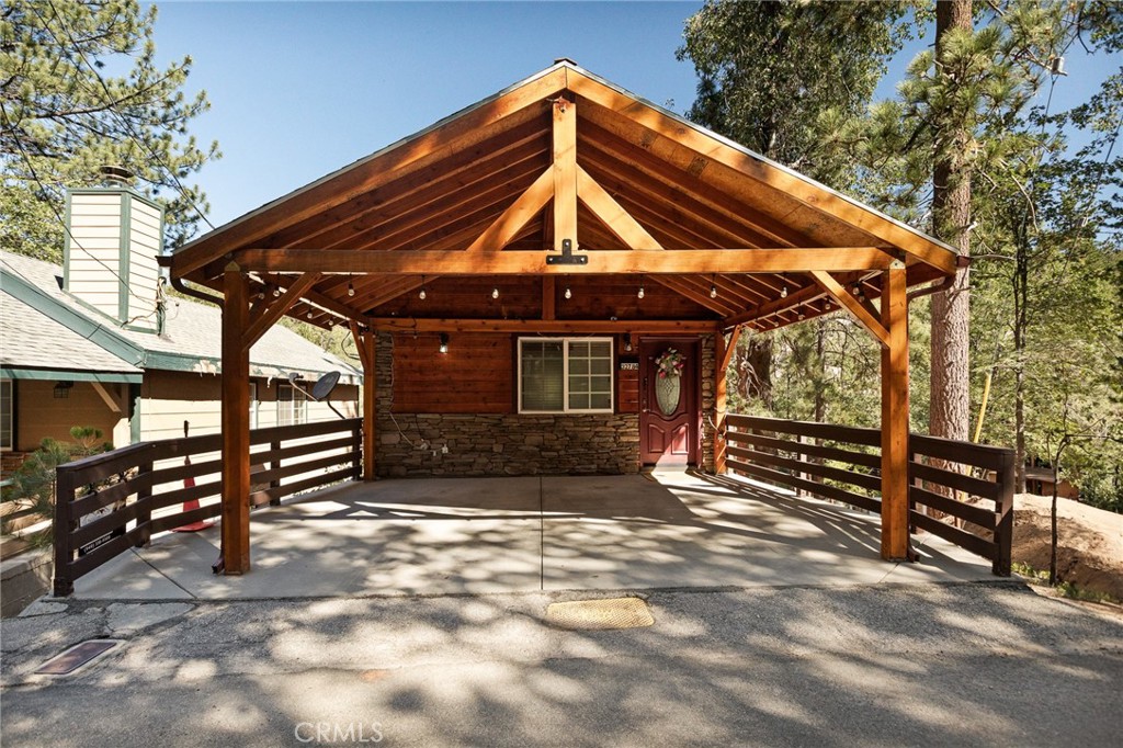 Discover your personal retreat with this cozy turnkey home, just steps away from the breathtaking national forest!! As you enter the main level, you'll be greeted by a spacious living room with GORGEOUS open beams, complete with a charming corner fireplace, a dining area next to a well-appointed kitchen featuring beautiful granite countertops and laminate flooring. This layout creates the perfect environment for meals and cherished memories with family and friends and you'll never be warm with air conditioning!! Enjoy the outdoors with decks on both levels, ideal for morning coffee or evening relaxation while soaking in the serene surroundings. The property boasts a beautiful two car carport. There is an apple tree, along with delicious raspberry, boysenberry, and black raspberry bushes, perfect for gardening enthusiasts. This home offers easy commuter access and is just minutes away from the enchanting Sky Park at Santa’s Village, the picturesque Lake Arrowhead Village, and the winter wonderland of Snow Valley. Whether you’re looking for a full-time residence, a weekend getaway, or an investment property, this delightful home in Arrowbear Lake is the perfect choice for those seeking charm and convenience. Don’t miss out on this opportunity to own your own slice of paradise! Call to tour today! Professional photos coming soon!!