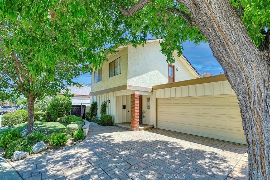 Welcome to this beautifully remodeled and meticulously maintained 4-bedroom, 2-bathroom home, perfectly situated at the end of a peaceful, tree-lined cul-de-sac in one of Valencia’s most sought-after neighborhoods—Old Orchard II. Step inside to discover a bright, naturally lit interior with tile flooring throughout the main living areas. The flexible formal living room is currently being used as a game room and can easily be converted back to a traditional living space to suit your needs. At the heart of the home is the remodeled kitchen featuring custom cabinetry, a charming farmhouse sink, and an abundance of natural light pouring in through expansive windows. The kitchen flows into a spacious family and dining area, offering an inviting view of your resort-style backyard. The main-floor primary suite serves as a tranquil retreat with a ceiling fan, oversized closet, and direct access to an upgraded en-suite bath showcasing granite countertops, tile flooring, and a walk-in shower. Upstairs, you’ll find three generously sized bedrooms with plantation shutters, and picturesque neighborhood views. The second floor remodeled, full bath is complete with granite countertops and stylish tile finishes. Unique touches like Dutch doors for the upstairs bedrooms and a whole-house attic fan add both character and practical comfort. Step outside to your private backyard oasis, featuring a covered patio, sparkling pool and spa with a waterfall feature, and plenty of room for entertaining, play, or simply relaxing under the stars. Modern smart home upgrades include four Kuna security cameras, Ecobee thermostat, WaterGuru pool monitoring system, and a smart garage door opener—all easily controlled from your iPhone. Additional highlights include paid-off solar, a 2-car attached garage with a laundry area including washer and dryer. Enjoy access to top-rated schools within walking distance, and a prime location just minutes from the 5 and 14 freeways, plus close proximity to the community pool, park, and clubhouse. Lovingly upgraded and truly move-in ready, this exceptional home is a rare find—don’t miss the opportunity to make it yours! Come experience the best of the Santa Clarita Valley lifestyle has to offer, with nearby amenities including scenic walking paseos, top-rated shopping and dining, Six Flags Magic Mountain, and College of the Canyons—all just minutes away.