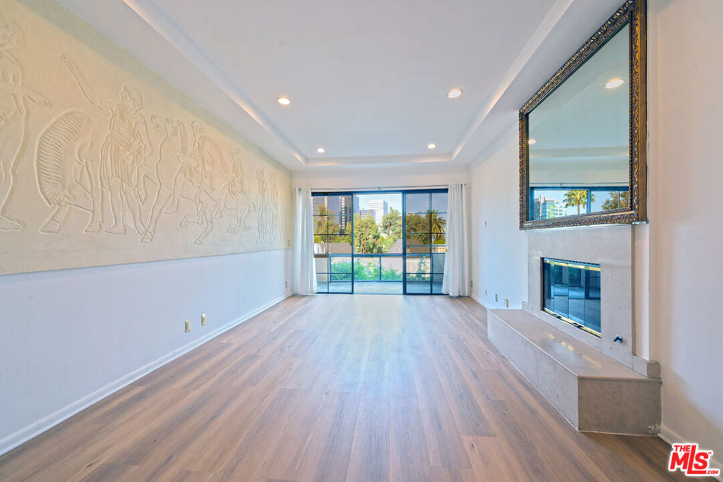 Exquisite Beverly Hills Penthouse with High Ceilings & Sweeping Views . Discover serene luxury in this recently remodeled two-bedroom penthouse in the prestigious "The Hamptons" complex. With a desirable split floor plan, each bedroom is positioned on opposite sides of the unit ideal for privacy each featuring its own en-suite bathroom, plus separate office and powder room w/sky lights. Step inside to soaring ceilings, new flooring, and abundant natural light from skylights and floor-to-ceiling windows that frame gorgeous open views. The spacious living room features a fireplace and opens to a large private terrace perfect for entertaining or relaxing under the stars. The stunning new kitchen boasts quartz countertops, sleek stainless steel appliances, and ample cabinetry. The luxurious primary suite offers downtown city views, a romantic fireplace, a generous walk-in closet, and a spa-like en-suite bath with separate soaking tub and glass-enclosed shower. The second bedroom also includes a walk-in closet and en-suite bath. Additional highlights: Side-by-side in-unit laundry, Two side-by-side parking spots. Resort-style amenities: pool, spa, fitness center, sauna. Unbeatable location near La Cienega Park, Beverly Hills Tennis Courts, The Beverly Center, fine dining, and houses of worship all within the acclaimed Beverly Hills School District. A rare find in one of L.A.'s most coveted addresses!