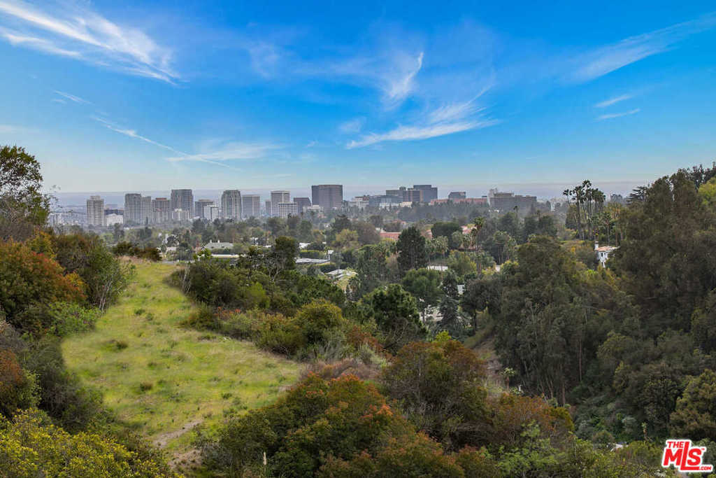 Fantastic Development opportunity with views, gated, and a large flat pad just minutes from the Beverly Hills Hotel. Unprecedented almost 2-acre lot with existing guest house and allowable square footage for an additional 10,000 sqft house. Build a multimillion-dollar house with views up a long driveway with a guest house and gatehouse minutes from Rodeo dining and shops. Bring all developers!