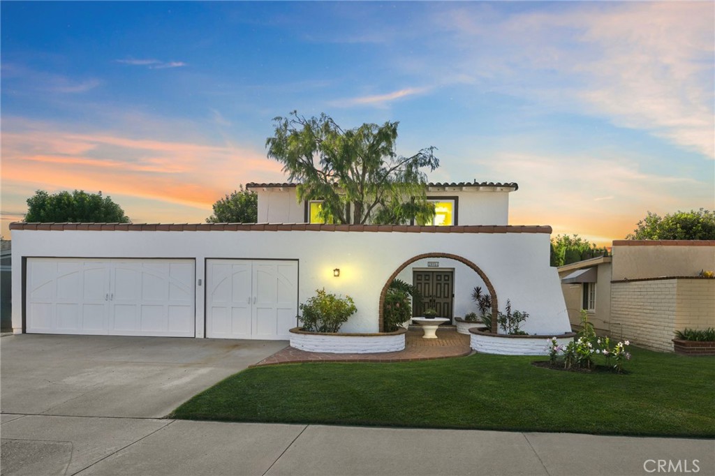 Welcome to 19051 Randi Lane, located in the desirable Glen Mar West neighborhood of Huntington Beach. This 4-bedroom, 2.5-bath, Spanish-style home offers a perfect blend of charm, space, and privacy. This interior lot home has been lovingly maintained and thoughtfully refreshed with brand-new windows, new interior and exterior paint, new flooring, and stylish updates that preserve its warm, welcoming character. Step inside to a light-filled living room with brand-new luxury vinyl plank flooring and expansive windows that flood the home with natural light. The adjoining family room features a cozy fireplace and flows seamlessly into the kitchen—ready for your custom touch. With backyard views and direct patio access, the kitchen offers a great canvas to design your dream culinary space. The spacious backyard is a true sanctuary, landscaped with mature trees—including citrus and a flourishing avocado tree. With no neighbors behind you, it's ideal for entertaining, gardening, or relaxing in the California sun. Upstairs, you'll find four generously sized bedrooms—all with high ceilings, fresh paint, and new flooring, plus a remodeled hall bath. The spacious primary suite offers soaring ceilings, abundant light, a walk-in closet, and a beautifully renovated ensuite with walk-in shower. Complete with a 3-car garage and located just minutes from top-rated schools, Talbert Park, and the best of Huntington Beach living. This is a rare opportunity to own a well-cared-for home with room to make it your own in one of the city’s most established neighborhoods.