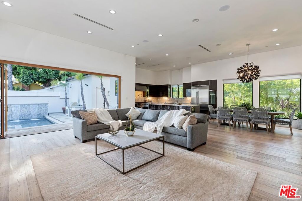 Welcome to a fully renovated Modern masterpiece situated south of the Blvd in the heart of Encino. Private and gated smart home boasts an open-concept floor plan with soaring 12-foot ceilings, white oak floors, a glass-enclosed fireplace, Venetian plaster accent walls, & recessed lighting throughout. A gourmet chef's kitchen with Euro quartz countertops, a grand island with bar seating, custom wood cabinetry, Viking appliances, two dishwashers, two sinks, a wine refrigerator, built-in microwave, pot-filler, and an 8 burner stove with dual ovens. This smart home features Control4 and Nest systems that control lighting, temperature, music, television, security cameras, doorbell, and a video intercom system. Master bedroom ensuite with a large walk-in-closet, custom light fixtures, a venetian plaster accent wall, an elegant dual sink vanity and separate makeup vanity master bath, and with access to an enclosed grass play yard. All bathrooms are en-suite, equipped with the finest fixtures and finishes, including quartz countertops, Toto toilets, Kohler sinks, Grohe fixtures and designer ceramic tile. Fully retractable glass doors that open to an entertainer's backyard with a sparkling heated pool, jacuzzi and BBQ grill with hosting areas which are perfect for lounging or entertaining alike. This home also features a 2-car detached garage, closets in every bedroom with built-in shelving, a remote-controlled drop-down shade in the backyard, and a water filtration system that runs throughout the house. Also available fully furnished short term.