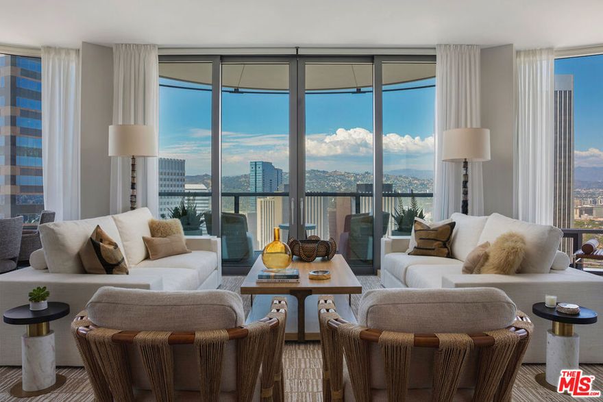 A custom-designed residence by McRae Lambert & Dunn, Residence 26C at the prestigious Century Plaza Park Elm is a one-of-a-kind one-bedroom plus den, offering unparalleled panoramic views to the north and east, facing the Wilshire Corridor and Downtown LA skyline. Upon arrival through a private elevator vestibule, you are welcomed by a grand formal entry foyer that flows into an expansive great room with 10-ft tall floor to ceiling windows. The den features rich walnut paneling and a travertine gas fireplace, creating an atmosphere of warmth and refined sophistication. The Snaidero-designed kitchen is equipped with Miele appliances and a custom slab waterfall island, blending sleek design with exceptional functionality. All rooms have operable windows which is unique in high-rise living. The primary suite offers dual custom Italian-designed closets and a luxurious five-fixture en-suite bath. Smart home features include Dual AC control, a Lutron lighting system and Palladium motorized shades. Residents enjoy world-class amenities including a resort-style pool, state-of-the-art fitness center, steam-equipped locker rooms, screening room, library, game room, personal wine storage, private dining rooms, guard-gated entry, and 24-hour concierge service.