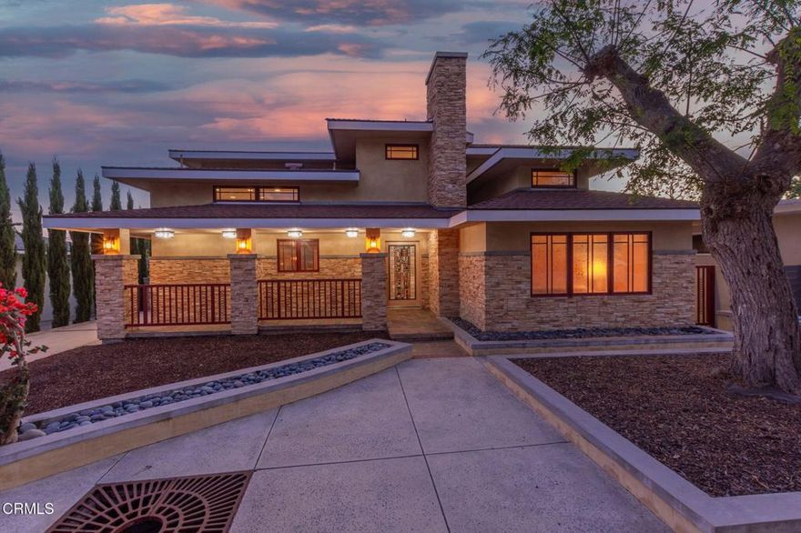 Architecturally striking and rich with character, 251 Palomares is a rare prairie-style residence that blends timeless design with modern comfort.  It was built new to reflect the era. Tall, wide and straight is evident throughout including the work of a master carpenter.Strong horizontal rooflines, stacked stonework, and custom lighting create a dramatic first impression, while stained-glass details and warm wood accents carry the artistry indoors.The entry opens to a thoughtful floor plan anchored by a stone fireplace framed with hand-crafted stained glass and elegant wood paneling throughout. Every detail has been carefully planned -- from the slate stone flooring to the custom light fixtures that add depth and warmth to each room.At the heart of the home, the chef's kitchen stands out with high-end appliances, abundant cabinetry, and generous prep space designed for both everyday living and entertaining. Upstairs, the grand primary suite offers a private retreat with a south-facing balcony, perfect for enjoying natural light and Ventura breezes. On the main level, a separate suite currently set as a private office provides flexibility for remote work or guest accommodations.Step outside to a spacious backyard deck surrounded by low-maintenance landscaping and hardscaping, ideal for gatherings or quiet moments at home. With its northeast-facing frontage, the home captures soft morning light while staying cool in the afternoons.From the custom wrought iron accents to the intentional architectural flow, 251 Palomares is more than a home -- it's a statement of design, craftsmanship, and California coastal living.