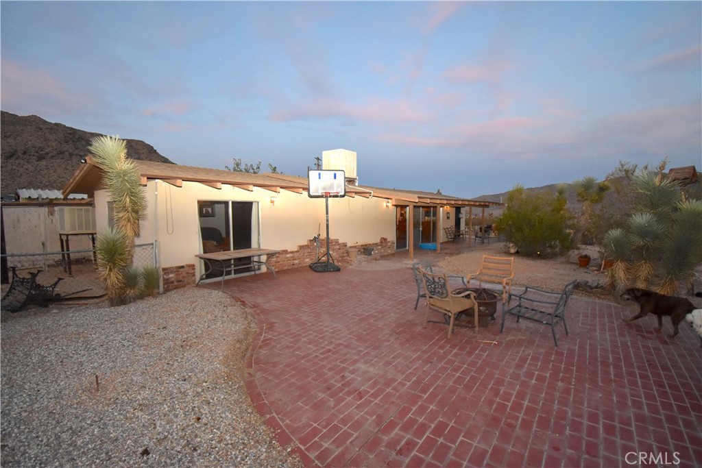 Wow, what a view from this house, two homes on a lot with a possible 3rd ADU. The main house built in 1961 has 2 beds one bath with a large patio area that has a view of the Victor Valley, the second dwelling sets up behind the main house with an view of the valley as well. it has a studio area with a separate bathroom. Behind that is a third possible ADU in the process of being remodeled. There is a detached single car garage. There are three additional covered area as well. All this on 5 acres what a spread!