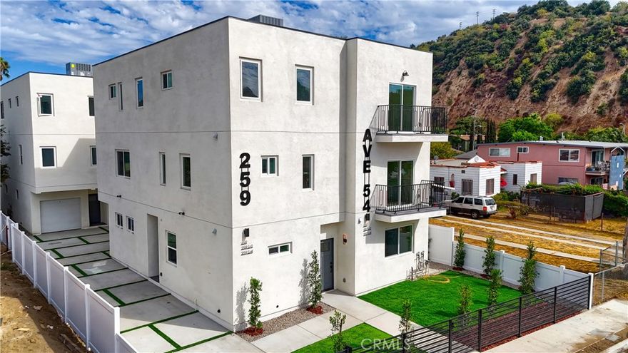 Brand New Construction in Highland Park! Welcome to 257 and 257 1/4 Avenue 54, a stunning 4-bedroom, 4-bathroom tri-level townhouse offering modern luxury and thoughtful design. Enter into a light-filled foyer and ascend to the expansive second floor, where the heart of the home awaits. This level boasts a spacious open-concept living and dining area with soaring ceilings, white oak flooring, custom iron railings, and abundant natural light. The chef's kitchen features a large center island, sleek white oak cabinetry, quartz countertops, and a complete brand-new stainless steel appliance package including refrigerator, range, dishwasher, and microwave. A private bedroom and full bathroom are also located on this floor, perfect for guests or a home office. The top level offers three spacious bedrooms, each with its own en-suite bathroom, providing privacy and convenience for every resident. A laundry area with washer and dryer is also located on this level for added ease. Designer touches continue throughout, from spa-inspired bathrooms with modern vanities and premium tile to recessed lighting and matte black hardware. Additional features include energy-efficient solar panels, EV charging capability, central A/C and heat, and secured parking. Be the first to live in this brand-new building that blends energy efficiency with contemporary style. Located in the heart of Highland Park, you'll enjoy easy access to York Boulevard's boutiques and coffee shops, the vibrant Figueroa Street corridor, and local favorites like Highland Park Bowl, Kitchen Mouse, Café de Leche, and Hippo. Just one mile to the Metro Gold Line and minutes from Downtown LA, Pasadena, and Dodger Stadium, this residence offers the very best of Highland Park living.