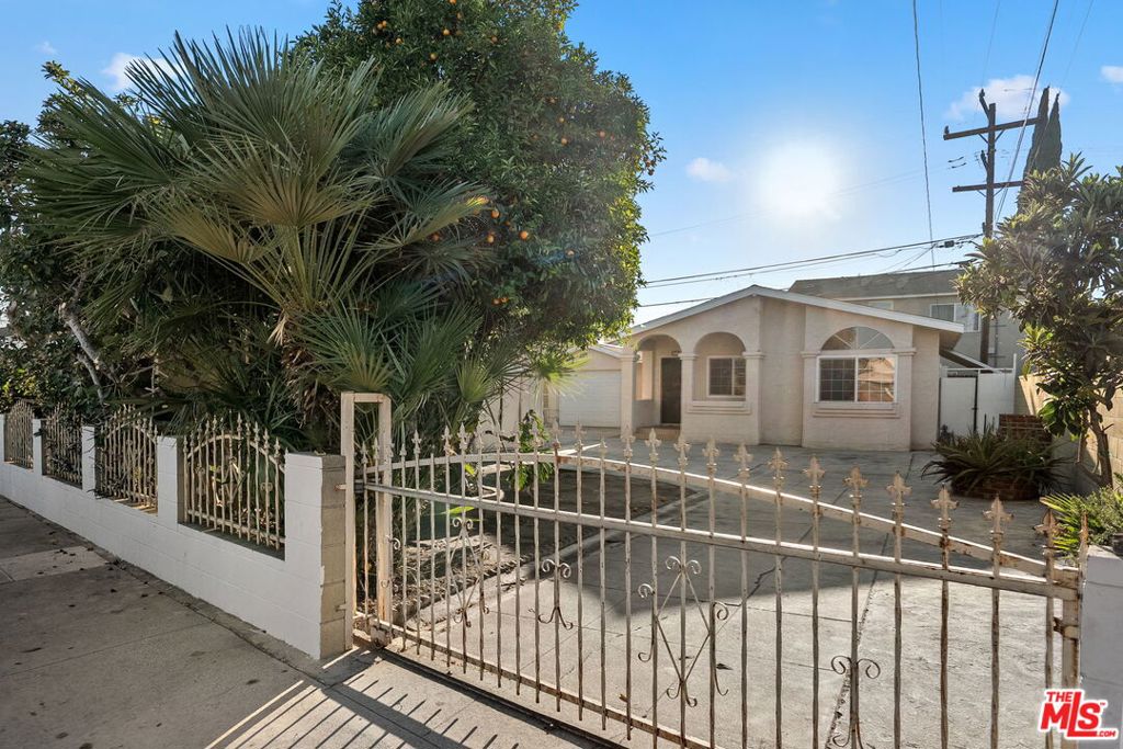 Welcome to 573 Belden Avenue, a charming single-story home in the heart of East Los Angeles, offering classic character, functional space, and room to make it your own. This gated property greets you with a spacious driveway, detached garage, and mature fruit trees that provide both shade and charm. The inviting front porch with its arched entry columns leads into a light-filled interior designed for comfort and versatility. Inside, you'll find a bright living and dining area with tile flooring and multiple windows that bring in natural light. The kitchen is thoughtfully laid out with wood cabinetry, tiled countertops, and plenty of storage, making it both practical and full of potential. Two generously sized bedrooms feature large windows and ample closet space, while two bathrooms offer convenience for family and guests alike. Additional highlights include a bonus space with its own bathroom, perfect for guests, a home office, or creative studio. The detached garage, long driveway, and gated front yard provide abundant parking and flexibility for future use. The backyard is a true blank canvas ideal for outdoor dining, gardening, or simply relaxing under the shade of your very own fruit trees. The lot is zoned LCR3YY and has development potential.