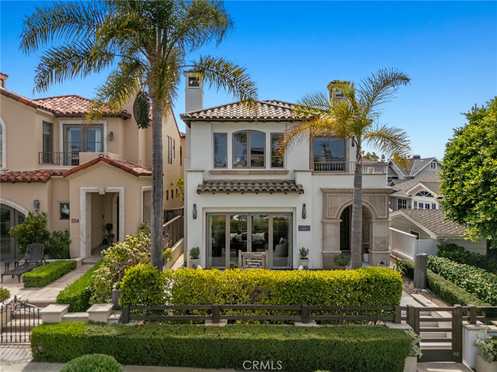 Nestled in the heart of Corona del Mar Village, on the “sunny side” of what is arguably the most desirable block in the Flower Streets, this coastal gem sits just five doors from iconic Inspiration Point and the sands of Big Corona. Designed for seamless indoor-outdoor living, the four-bedroom residence connects to multiple outdoor spaces, including a sunlit front patio with 4-panel folding doors, perfect for afternoon sun and evening entertaining.
The modern kitchen, with high-end appliances and a spacious island, flows into a welcoming family room with a fireplace and adjacent breakfast patio, ideal for gatherings or quiet mornings.
Upstairs, the primary suite features a private balcony and fireplace for a cozy retreat. Three additional bedrooms and two decks offer flexibility for guests or fitness, while the rooftop deck and “crow’s nest” office with half bath capture expansive views of the coastline, Catalina Island, and boats entering and exiting Newport Harbor.
Steps to Corona del Mar’s vibrant shops, dining, and beaches, this home delivers prime coastal living. At nearly 34 feet wide, the wider-than-standard lot offers well-proportioned living space along with the rare convenience of parking for four (4) vehicles, including a tandem three-car garage, plus carport.