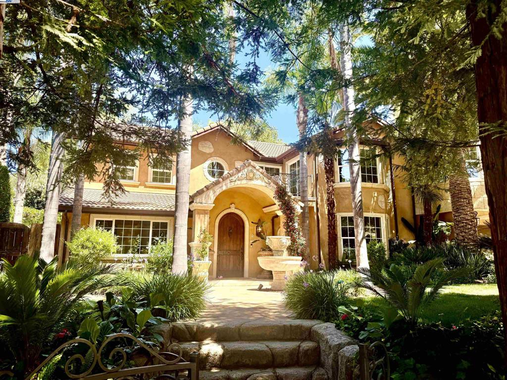 A rare corner-lot estate offering what most homes in Danville can’t—space to create exactly what you need. With a custom beach-entry rock pool, grotto, and sports court already in place, this expansive 16,988 square foot lot still offers room to build. City provided ADU designs plans available, making it easier to add flexible living space, expand garage capacity, or explore potential SB9 lot split opportunities (Buyer to verify). In a market where space is limited, this property delivers the versatility today’s Buyers crave. Inside, the home blends timeless architecture with modern comfort: formal dining, spacious living areas, and a chef’s kitchen designed for gatherings. The au pair suite with private entrance, kitchenette, and full bath offers flexibility as a 5th bedroom, home office, or guest quarters. Upstairs, the primary suite is a true retreat with a private balcony overlooking the resort-style backyard, spa-inspired bath, and dual walk-in closets. A junior suite with Tuscan balcony, plus two additional bedrooms and a full bath, complete the upper level. Located near award-winning schools and town, this is a signature opportunity to create the dream property you’ve been waiting for.