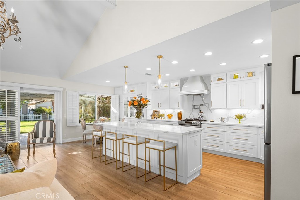 Drawing on clear principles, the owners created sophisticated spaces characterized by muted tones, rich textures and vintage pieces that span throughout the property. The home is a blend of old and new with a refined yet contemporary lens. Inside, this effortless layout consists of three bedrooms and two full bathrooms, along with a collection of formal and informal areas for dining, relaxation, and entertaining. Immediately upon walking in, the vast ceiling heights give the properties great room a sense of grandeur, this sets the stage for the remainder of the property. The kitchen acts as the families main gathering place, with its open access to both living and dining areas, its setting truly acts as the heart for entertaining. Its custom cabinetry, immense center island, and classic styling only add to the significance of the room. Outside, the open but private patio is perfect for entertaining or simply basking in the lakeside ambiance which is only steps away from the water. In the primary bedroom, the owner created a sense of calm with a soft color palette, while the primary bathroom features an updated space with its sizable walk-in shower as the centerpiece. On this side of the property, you'll also find two additional bedrooms apart from another full bathroom. Every facet of this property has been thoughtfully curated to offer a living experience that is not only practical but warm, inviting and visually striking. The result is a dynamic, contemporary family home that perfectly responds to its lakeside locale.