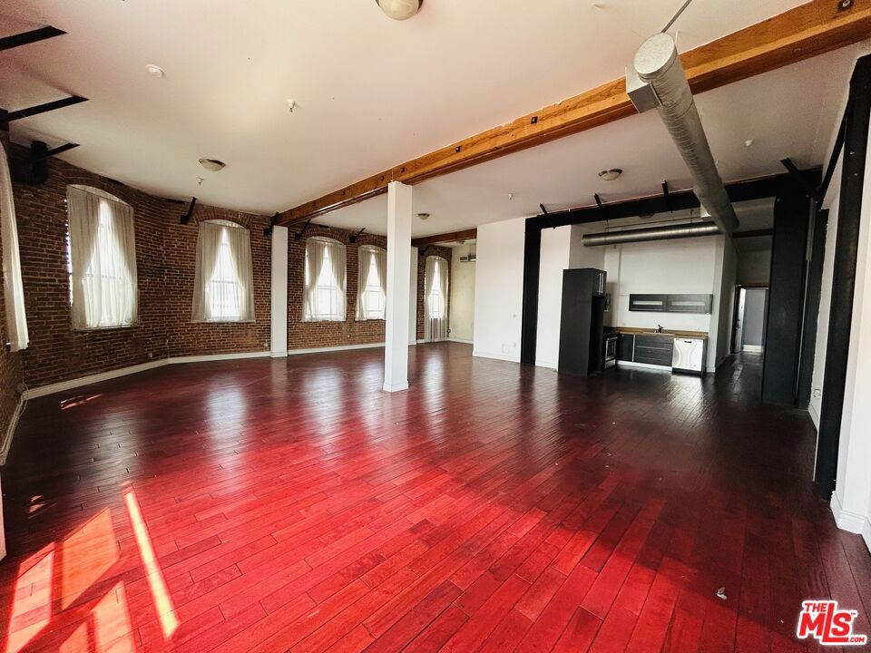 **Price Improvement. The actual Lease Rate is $3,400; the advertised rate of $3,158 is based on a 14-month lease term with a 1-month lease concession included.** Experience an authentic loft lifestyle in the heart of the arts district! Situated in the historic Brick Lofts is this live/work loft that offers the best of both worlds; Historic architectural details including exposed brick walls and exposed wood beams + posts, coupled with modern amenities including a kitchen with stone counters, stainless steel appliances, and large island with breakfast bar as well as a bathroom with separate tub and shower. Other highlights include hardwood floors, central HVAC w/exposed industrial grade ducting, and washer/dryer hookups. Ideally located next to some of the best bars, restaurants, shopping, and entertainment in the arts district and super convenient access to freeways and public transportation. This is a must see for those seeking a space that is outside the norm, a space that signifies the "arts" in "arts district". **Zoned Live/Work** Renter is responsible for gas and electricity. Water, trash and sewer are covered by the landlord. Tenant to provide their own fridge, washer, & dryer.