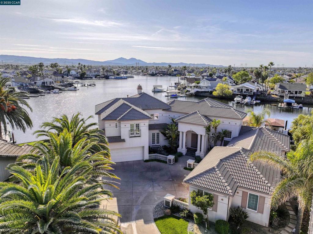 Truly spectacular one of a kind custom waterfront estate located in exclusive Discovery Bay gated community. Breathtaking panoramic water views with 207 feet of water frontage. Large double-U dock, with room to expand to accommodate any boat. One of the largest waterfront lots in Discovery Bay (16,700 sq ft). Garage parking for 6 cars plus potential to add car lifts (tall ceilings). Wired for electric car charging. 4 bedrooms plus office. Potential for second primary suite downstairs. Truly unbeatable views, including stunning Mount Diablo sunsets. Perfect for indoor/outdoor living and entertaining. First time on the market!