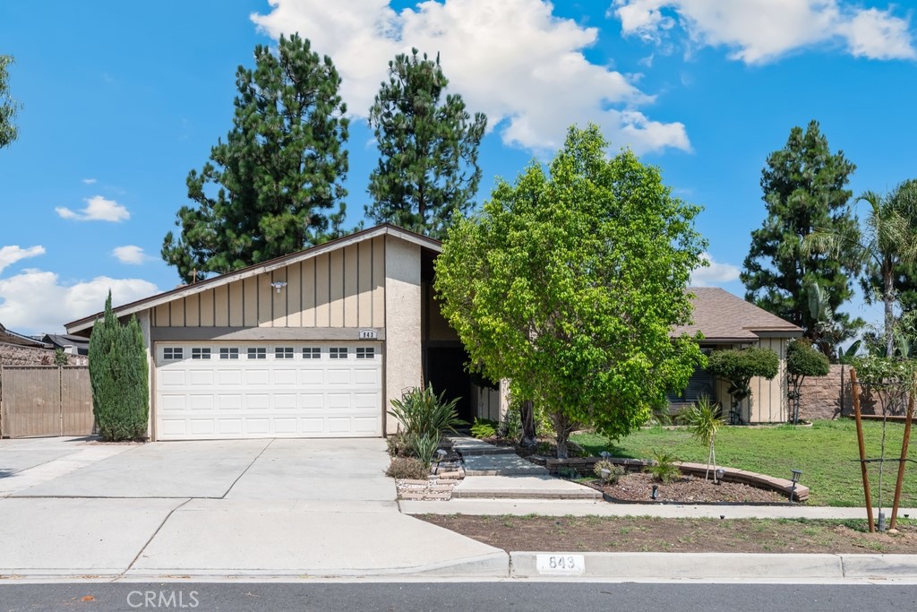 Spacious SINGLE STORY home with great curb appeal located in wonderful Corona neighborhood with no HOA fees, no Mello Roos, an attached 2-Car Garage and GATED RV Parking! This 4 bed/2 bath home offers 1,615 Sq Ft of living spacious and sits on a Premium 9,148 Sq Ft Lot. The interior offers tile and wood flooring. Enter into the living room with fireplace and lots of natural light. The kitchen has tile countertops and lots of cabinetry storage space. The kitchen opens to the dining area which has a slider to the backyard. All 4 bedrooms are generously sized with the main bedroom sitting at the end of the hall and featuring a private slider to the backyard and a private bathroom, there is also a full-size hall bathroom for the 2 secondary bedrooms and guests to share. Enjoy the private, flat, backyard that is ready for the new owner's design, there is also a covered patio and pergola to relax and entertain under and plenty of space to make your own! This home is conveniently located near Kellogg Park, as well as schools, shopping, dining, and not far from the 91 and 15 Fwys! ~~ NO HOA! Low Tax Rate!! LOCATION~~ LOCATION~~~ LOCATION~~